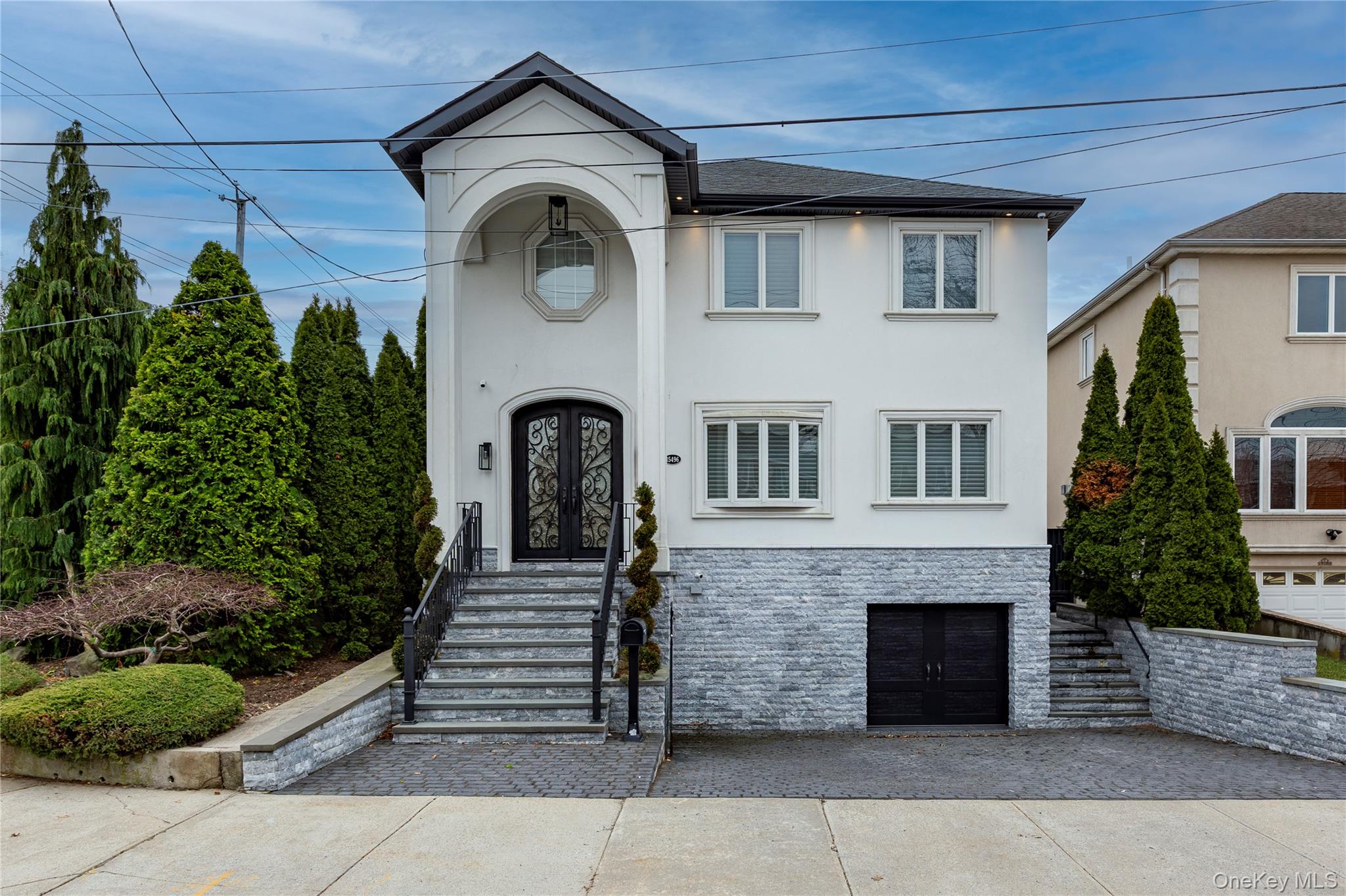 154-96 Riverside Drive | Whitestone, NYA Masterpiece of Modern Luxury LivingWelcome to this fully customized smart home on a premier 60x100 corner lot in Whitestone, offering approximately 4,000 square feet of living space (excluding the finished basement), with four bedrooms, two full and two half baths.Radiant heated floors on the first level, heated second-floor bathrooms and laundry, central air, and individual climate controls in every bedroom provide ultimate comfort year-round. A gas fireplace anchors the main living space.Designed for modern living, the home features full smart home integration with app-controlled lighting and systems. Enjoy in-ceiling Bose speakers throughout, a Sonos audio system, and surround sound in both the living room and finished basement for a seamless entertainment experience.The chef’s kitchen is equipped with top-of-the-line Wolf and Sub-Zero appliances, including an 8-burner stove, built-in espresso machine, double Bosch dishwashers, wine fridge, disposal/compactor, and two farmhouse sinks with point-of-use filtration. A custom pantry with a pullout desk adds convenience, along with a first-floor powder room.Upstairs, the king-sized primary suite offers a spa-like en-suite bath and California Closets, with Restoration Hardware chandeliers enhancing every bedroom. A top-floor laundry room completes the level.The finished basement extends the living space with indoor-outdoor flow, ideal for entertaining.Outside, enjoy a private resort-style setting with a heated saltwater pool (7 ft to 3 ft) with automated cover, plus an outdoor kitchen featuring a Wolf barbecue and Blaze refrigerator.A rare opportunity to own a turn-key luxury smart home combining scale, comfort, technology, and high-end finishes in one of Whitestone’s most desirable locations. Featured Residential Sales.
