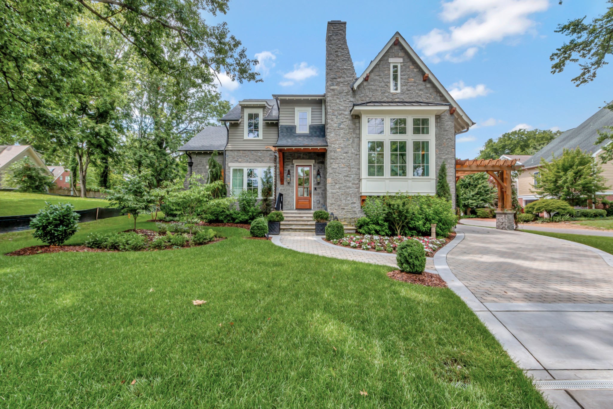 Platinum Winner of 2024 National Homebuilders Assn. "Best of Kind" Custom home for square footage. MK Studios architect. With 3946 SF in the main house and 968 SF in Carriage House, attached by a covered breezeway there is a total of 4914 SF of living space in this custom home. 4th BR/Flex rm & Art Studio is in Carriage house A storybook modern Tudor home located in Downtown Franklin. TN grey limestone. Exposed timber beams custom scroll rafter tails. Site includes permeable paver drive, blue stone patio surrounding gunite heated pool w/3 waterfalls. The main house includes 3 ensuite BR, powder rm, playroom/den sunroom, dining and larger grand foyer w/22 ft ceiling, gas fireplace in addition to a great room w/20 ft ceiling, fireplace, a gourmet kitchen with built in China cabinet, and scullery. Primary suite on main.  There is a whole house dehumidifier. Other features include 48 inch Wolf Stove, Wolf microwave, 42 in Sub Zero refrigerator, Thermador steam oven, Sub Zero wine refrigerator with 2 refrigerator drawers, two warming drawers, wet bar, designer light fixtures throughout, hidden Christmas tree closet. A short stroll to The Factory of Franklin and Historic Main Street. More photos to come.