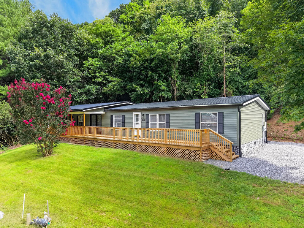 Completely remodeled and move in ready! This 4 bedroom, 2 bath doublewide with an addition offers approximately 1,944 finished sq. ft. and sits on just over 3 acres in town. The extensive updates include a new metal roof, gutters, vinyl siding, flooring, paint, fixtures, two brand new heat pumps, updated bathrooms, and more! The primary suite features a large bedroom and bathroom, while the spacious living area opens directly onto a new, expansive front deck that is partially covered. A new back porch provides even more outdoor space. All brand new appliances convey! The freshly graveled driveway offers plenty of parking, plus there is a detached carport. Outbuildings provide additional storage, along with an older garage. Located directly across from the county high school and within walking distance of the post office and local retail store, this property is less than a mile from I-77 at Rocky Gap, right near the Virginia/West Virginia line. Furnishings may be included with an acceptable offer. A fantastic opportunity to own a beautifully updated home in a convenient location!