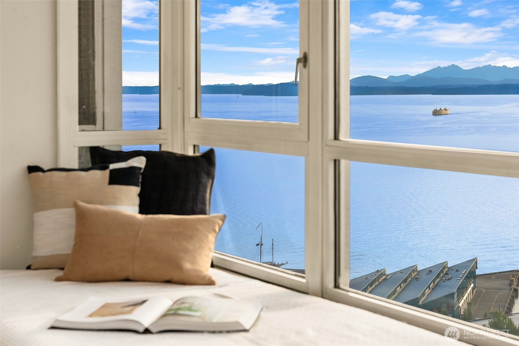 Spectacular 180-degree views span the Olympic Mountains, Puget Sound and wrap around to the Space Needle. A rare single-owner residence for over 30 years, this fully renovated two-level NW- and north-facing townhouse at Continental Place offers double-height ceilings and walls of glass, creating a light, airy feeling. Modern Scandinavian design, or “hygge,” best describes this no-expense-spared renovation, with clean, elegant lines and inviting, relaxing spaces. The two-level layout easily accommodates distinct public and private spaces, ideal for both everyday living and entertaining. Multiple cozy window seats provide inviting gathering spaces and comfortably accommodate large groups, while potentially offering additional square footage not reflected in tax records. The new kitchen features top-of-the-line appliances, complemented by two new baths and new hardwood floors throughout. The second bedroom wall was removed and is currently non-conforming. Newer washer/dryer and portable A/C included. Generous storage, one parking space and storage unit are included. Continental Place amenities include 24-hour doorstaff, pool, gym, spa, private event space, sculpture garden and on-site guest suite. Facilities manager M–F and professional management.
