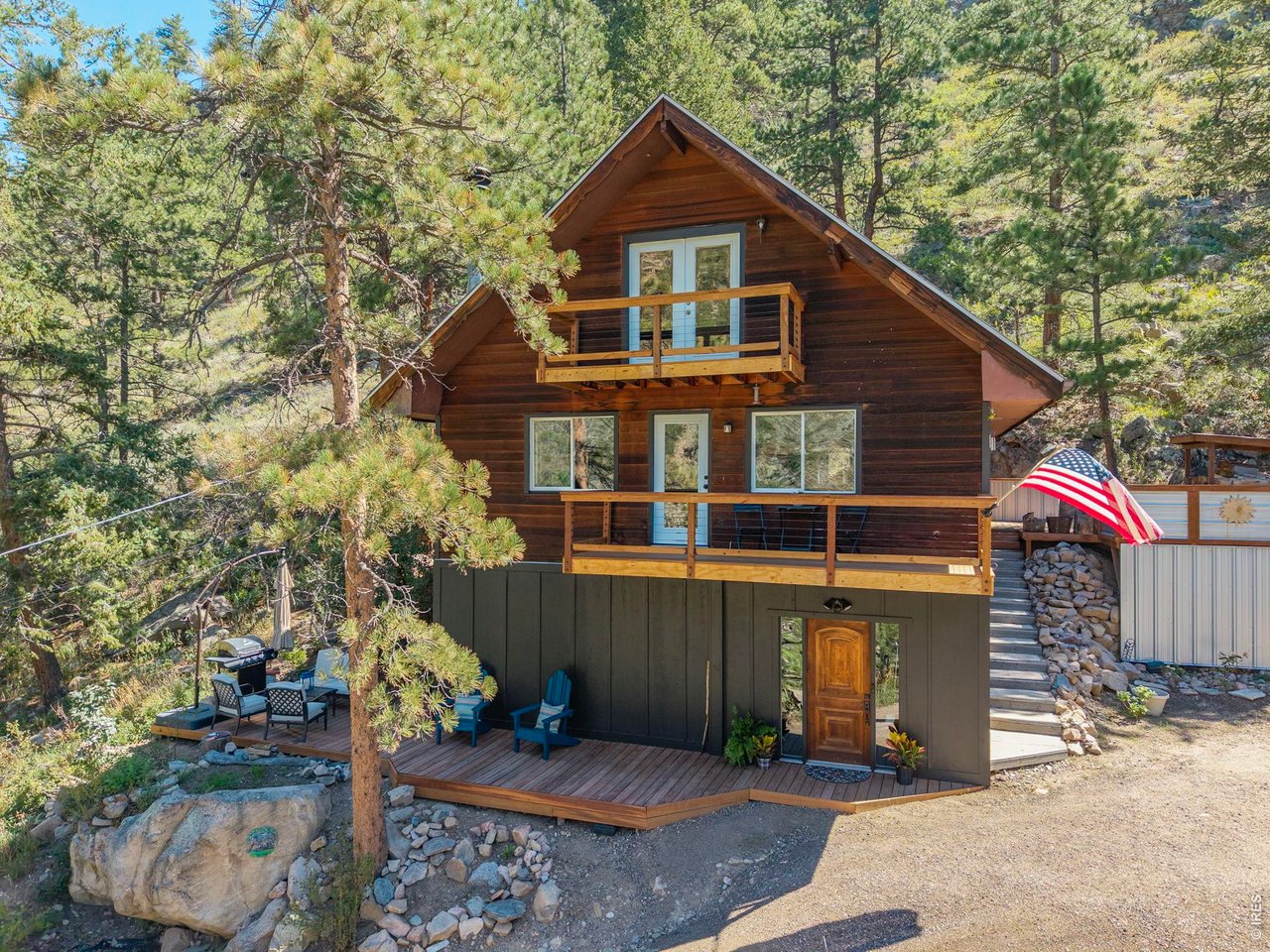 Beautifully transformed with extensive recent updates, this Big Thompson Canyon home combines thoughtful craftsmanship, modern functionality in an exceptional natural setting. The fully remodeled kitchen is a standout, featuring leathered granite countertops, solid maple cabinetry, stainless steel appliances, double wall ovens, a ducted hood, porcelain tile backsplash, updated lighting and wide-plank 3/4-inch solid maple flooring. The inviting living room retains its mountain character with a wood-burning fireplace surrounded by natural moss rock, while the former attached garage has been thoughtfully reimagined as a spacious entry mudroom and separate laundry room. Multiple levels and outdoor living spaces-including covered balconies, an uncovered porch and a wood deck-provide numerous places to enjoy the forested canyon surroundings and views toward the Big Thompson River below. The property backs directly to Roosevelt National Forest, providing immediate access to thousands of acres of public land, while high-speed Pulse internet adds an important modern convenience. Conveniently located near the junction of Highway 34 and County Road 43, the property sits approximately halfway between Loveland and Estes Park-just 13 miles from Estes Park and 16 miles from Loveland, with the entrance to Rocky Mountain National Park approximately 16 miles away. This beautifully updated home offers an uncommon combination of craftsmanship, recreation, accessibility and connection to the natural surroundings of the Big Thompson Canyon.