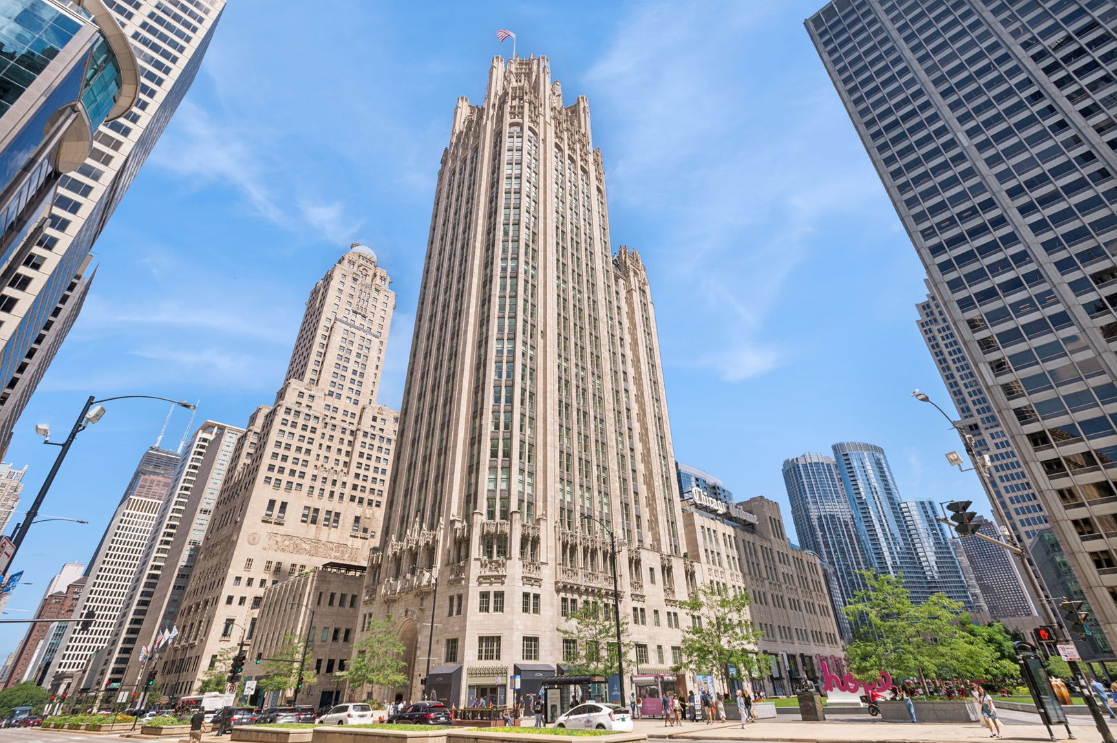 This incomparable property rests high above Chicago's Magnificent Mile at one of Chicago's most exclusive addresses: The Tribune Tower.  Timeless elegance is seamlessly blended with the state-of-the-art.  This is a treasure. This wonderful unit has a commanding south city view: the Chicago River, Michigan Avenue Bridge, and many world-famous architectural landmarks. The front door opens to an elegant foyer crowned with a shimmering chandelier that accents subtle hessian wallpaper. This smart technology condominium gives efficiency and convenience. The heated White Oak Character Grade floor offers a splendid foundation that passes from room to room, framed by a precise molding. An immediate right turn leased into the breathtaking Living Room framed with a crown molding. An Astria Atlas Vent Free Gas fireplace with silver beige polished marble hearth and surround with custom trim charms the room. The Lutrin blind system gives added exclusivity. A first-class kitchen appeals to the most discerning tastes: Sub Zero Designer Column Freezer with internal ice maker, Wolf gas range with four burners and infrared griddle, Best built-in range hood with integrated lighting and exhaust in custom stainless enclosure, Meile dishwasher.  Frank garbage disposal. Kitchen counters and backsplash are Perla Venata quartzite with eased edged. Galley workstation has single bowl double tier under mount sink with single pulldown faucet. Premium grade hardwood drawers and wood shelves offer excellent storage. Drawer fronts and panels are premium white maple with Medex center panels. The extra spacious Living Room sports ten foot ceilings. The elegant Dining Room delights with its beautiful chandelier. This grand room leads to the balcony with its epic views. Complete with aluminum terrace door by Graham Architectural Products, Sterling Dulan Glass Rail, porcelain paver tiles - this balcony has it all. Three full baths and one powder room are will appointed with Kohler and Waterworks fixtures. The powder room has vintage Herringbone pattern white oak flooring. Master bath counter has silver beige polished marble countertop with Carrara Venizia marble tile, shower floor and inlay. Secondary bath has Atlas Concorde Marvel Gray Fleury tile floor and inlay. Secondary bath walls are Stone Source Resort Bianco Matter tile. The Family Room has the custom designed parallel walls, bar with mirrored, illuminated backing and onyx topped cabinets, wine fridge, floor-to-ceiling windows. Walk in closets have custom shelving and recessed lighting. Laundry room has matte finish thermally fused laminate flat slabs, flush mounted designer features, LG washer and dryer. 55,000 feet of amenities defines a new level of luxury. Conference room, tv viewing room, piano, bar, and more. Magnificent fitness center has 75-foot pool, sauna, steam room. Golf practice tee and simulator on second floor.  Garage level has dog walk. Outdoor terrace and sun deck flanked by buttresses that transcend anything in the city.  Twenty-four-hour door staff and concierge service. Easy access to great shopping and world class cultural centers. Two prime deeded parking spaces included in the price. A must see