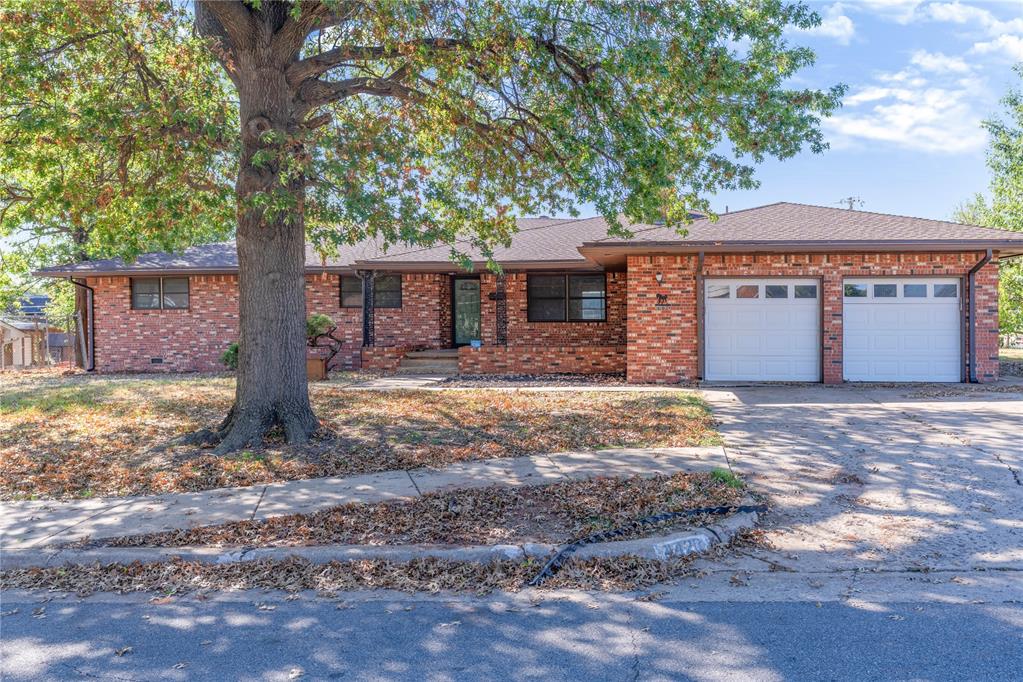Move-in ready and ideally situated in a prime Northwest Oklahoma City neighborhood close to shopping, dining, and easy highway access, this spacious 4-bedroom, 2.5-bathroom home offers exceptional layout versatility. Rich stained wood flooring flows through two distinct, spacious living areas, providing ample room for formal gathering, casual relaxation, or entertaining. The main living room centers around a classic brick fireplace flanked by custom built-in cabinetry for timeless warmth and storage. Right off the living space, a functional kitchen features abundant cabinetry storage, an adjacent dining area, and a conveniently located half bath for guests. Complete with a 2-car garage, generous bedrooms, and flexible living options throughout, this home is ready for its next owner. Reach out today to schedule your private tour!