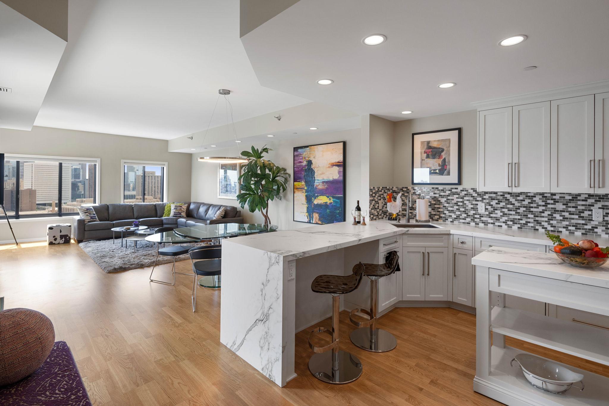 Enjoy breathtaking panoramic River and Skyline Views from this beautifully remodeled 21st floor unit at the iconic La Rive Condominiums. This 2 Bedroom, 2 Bath spacious floorplan includes a cook’s kitchen with commercial-grade Thermador Refrigerator and Dishwasher, GE Convection Cooktop and Oven. In addition, a Miele Steam Oven and Warming Drawer located in the expanded kitchen pantry with an abundance of extra storage. New hardwood floors, new doors/hardware, new lighting as well as window blinds throughout. Two sliding doors lead to a patio with stunning views of the city and sunsets. Both bathrooms have been remodeled with new tile, countertops and cabinets, new plumbing fixtures and soaking tub. Primary bedroom boasts two oversized walk-in closets and large corner window with city views. Large walk-in laundry includes full-size washer/dryer and new cabinets. In-unit HVAC recently replaced and located adjacent to laundry. Enjoy the Historic Riverwalk Landmarks such as St. Anthony Falls, Stone Arch Bridge, and the Classic Cobble Stone Main Street connecting Hennepin Avenue, Father Hennepin Bluff Park and Nicollet Island. Watch spectacular fireworks from your private balcony – truly a front row seat to the city’s most picturesque sights. Amenities include 24-hour concierge, guest suites, indoor pool/hot tub, fitness room, sauna, steam room, meeting rooms and oversized riverfront terrace. Live in the heart of one of the fastest growing neighborhoods with award-winning restaurants, Lund’s/Byerly’s and shopping galore – all within walking distance. Welcome home!!