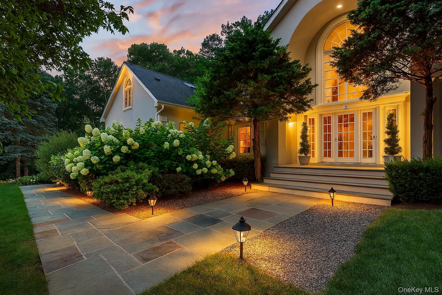 Experience refined living in this Masterpiece of Design and Detail. A Custom home with show-stopping gourmet kitchen, luxurious beautifully appointed baths and a resort-style saltwater pool surrounded by Bluestone patio and walkways, mature landscaping.  Step inside to a beautiful two story foyer with marble flooring and handcrafted oak staircase that sets the tone for the quality construction and design elements of this home.  Thoughtfully designed and solidly built, this home features a spacious layout with hardwood floors, custom millwork, and abundant natural light from oversized windows.  The main level offers an open, easy flow—perfect for entertaining or everyday living—centered around a double-sided, floor-to-ceiling stone fireplace. The large gourmet kitchen is appointed with a generous island with a nickel farm sink, granite countertops, top-of-the-line appliances, and a substantial 7-inch butcher block.  Upstairs features 4 generously sized bedrooms, including a primary suite with Fireplace, a spa like bathroom, 2 custom closets and a sitting area perfect for quiet reading, office or exercise.  3 additional bedrooms on this level include a guest suite with an attached bath.  A Unique Office, designed with reclaimed wood, makes it a perfect retreat. This home features a back staircase that leads to the two levels below. Additional highlights include heated three car garage with tall ceilings, gated driveway with stone inlay, lawn sprinklers and whole home generator.  Located in a peaceful setting yet close to town, this property offers privacy, space, and comfort – Not To Be Missed.