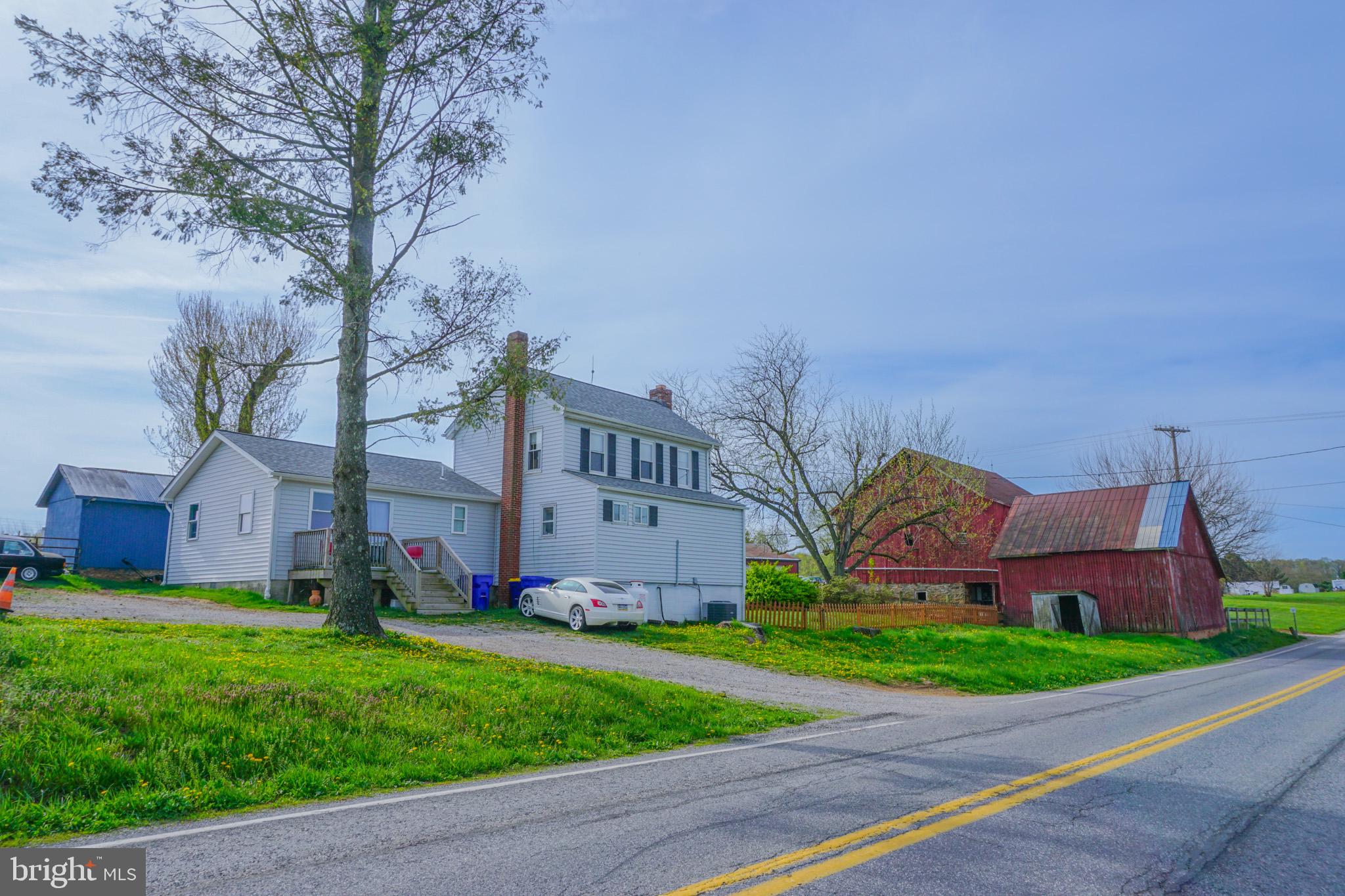Beautiful 8-acre property offering a perfect blend of open land and wooded privacy. Approximately 5 acres are tillable or suitable for pasture, with an additional 2 acres of woods. The property features a large barn with stalls, as well as a pole barn with a 2-bay garage and electricity—ideal for hobby farming, livestock, or storage.The 1,721 SF home includes 3 bedrooms and 2 full baths, with both a full kitchen and a kitchenette. The layout is well-suited for in-law quarters on the first floor, providing flexible living arrangements. A small fenced yard and separately fenced pasture complete this versatile property.