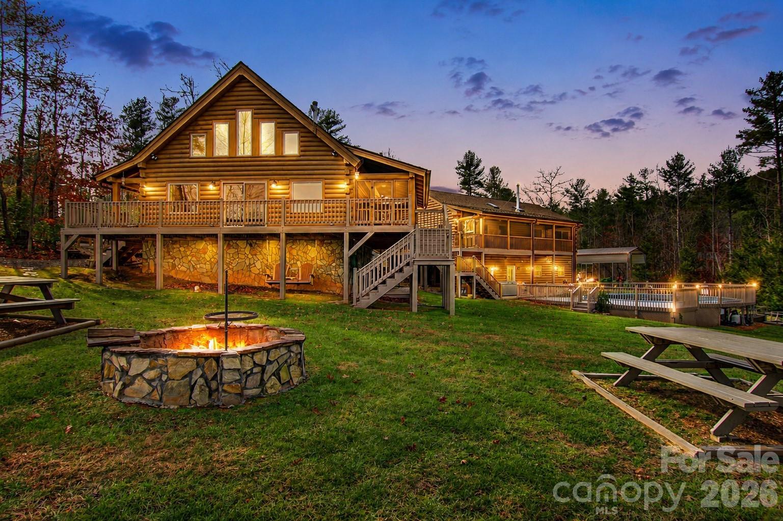 Find freedom in this 10.5+ acre mountain sanctuary—an ideal homestead for those seeking a more self-reliant way of living. Welcome to 2257 Quiet Creek Lane, a private retreat designed for self-sufficiency, privacy, and multi-generational living within a gated community.Thoughtfully developed as a functional mini-farm, the land features raised garden beds, greenhouse, fruit trees, chicken coop, compost system, and a protected apiary area. Trails lead to a spring-fed creek, enhancing both the beauty and sustainability of this serene setting.The property includes two custom Coventry Log Homes. The main home (2013) offers 4BR/3BA and ~1,963 sq ft with long-range mountain views and a screened porch. The second home (2016) features 2BR/2BA, open living, wood stove, screened porch, and a walk-out basement with bonus room, full bath, laundry, and 2-car garage. A connecting breezeway provides flexible space for a studio, office, or shared gathering area.Additional features include a climate-controlled bunkhouse with full bath, a powered workshop, multiple camper hookups, plus a pool, hot tub, and fire pit—perfect for enjoying this private sanctuary with family and guests.Designed with resilience and independence in mind, the property includes solar panels (~65% of power needs), propane generators, and Starlink high-speed internet—offering the ideal balance of self-reliance and connectivity.Located just 20 minutes to Lenoir and ~35 minutes to Blowing Rock and Morganton, with access to Pisgah National Forest, Johns River, and Brown Mountain Beach.A rare opportunity to own a true mountain sanctuary where you can live, grow, and gather for generations to come.