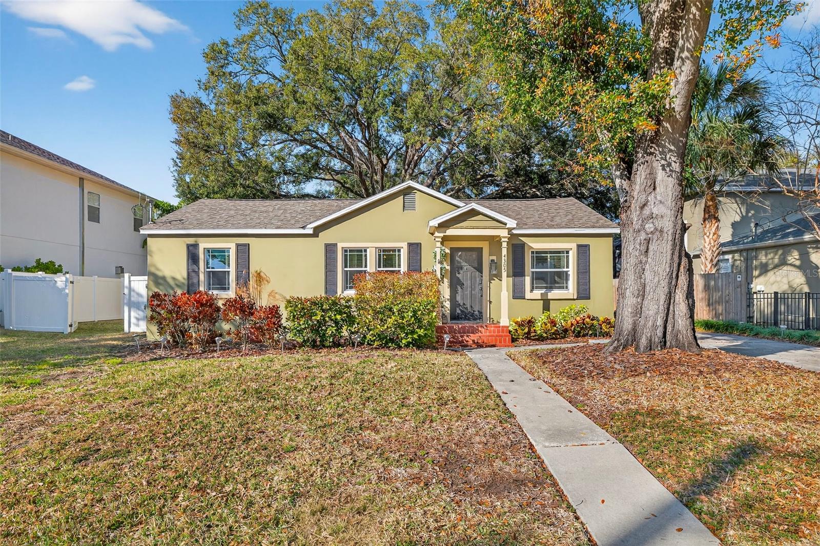 Tucked beneath a canopy of mature trees in the heart of South Tampa, this timeless residence invites you into a lifestyle defined by charm, connection, and everyday ease. Set on a generous 75 x 120 lot, this property offers the space to breathe, gather, and grow—all while being moments from the very best the city has to offer. Zoned for the highly sought-after Mabry, Coleman, and Plant school district, this home places you in the center of it all. From the moment you arrive, there’s a feeling that life simply fits here. The welcoming façade and expansive driveway greet family and friends with warmth, while inside, rich heart of pine wood floors stretch throughout the living spaces, telling a story of craftsmanship and character. With four bedrooms (4) and two baths (2), flexibility abounds. The primary owners retreat features soaring cathedral ceilings and an ensuite bathroom. There is also a guest suite with its own private entrance, ideal as a Mother-in-Law suite, offering independence and privacy for extended family or long-term guests while remaining thoughtfully connected to the main home. Thoughtful updates blend seamlessly with the home’s original soul, creating a space that feels both established and refreshingly current. A spacious family room flows into a dedicated dining area, creating a natural gathering place for holidays, celebrations, or relaxed dinners. The kitchen, complete with granite countertops, newer stainless-steel appliances, invites culinary creativity—whether you’re preparing Sunday brunch before a Bayshore stroll or hosting friends before a night out in Hyde Park. Just off the kitchen, a screened-in lanai offers the perfect spot for morning coffee or evening wine, seamlessly blending indoor and outdoor living. A newer roof (2021) provides peace of mind, and the home has never sustained storm damage—a rare and valuable distinction. Newer Energy-efficient windows enhance year-round comfort, while an interior laundry room adds daily convenience. Step outside and discover where this property truly shines. The expansive fenced backyard feels like a private park—ready for memories to unfold. A newer deck spanning the entire width of the home creates an incredible extension of the living space, perfect for hosting large gatherings, grilling with friends, or dining under the stars. The screened lanai and full-width deck work beautifully together—one offering shade and comfort, the other open-air space for celebration—creating a backyard designed for year-round enjoyment. Imagine birthday parties under café lights, gardening on sunny afternoons, or quiet evenings gathered around a fire pit. Tucked into this remarkable yard is an air-conditioned workshop built on a concrete slab with insulated framing and windows—a versatile space limited only by your imagination. Today it’s a workshop; tomorrow it could be your private gym, art studio, home office, or an inviting guest retreat. Location here is more than convenient—it’s lifestyle-defining. Hyde Park Village’s boutiques and cafés are minutes away. Morning runs along Bayshore Boulevard, evenings in vibrant Downtown Tampa, quick departures from Tampa International Airport, and spontaneous weekends at the Gulf beaches are all within easy reach. This is more than a home—it’s a place where character meets comfort, community thrives, and where every day feels grounded, inspired, and unmistakably South Tampa.