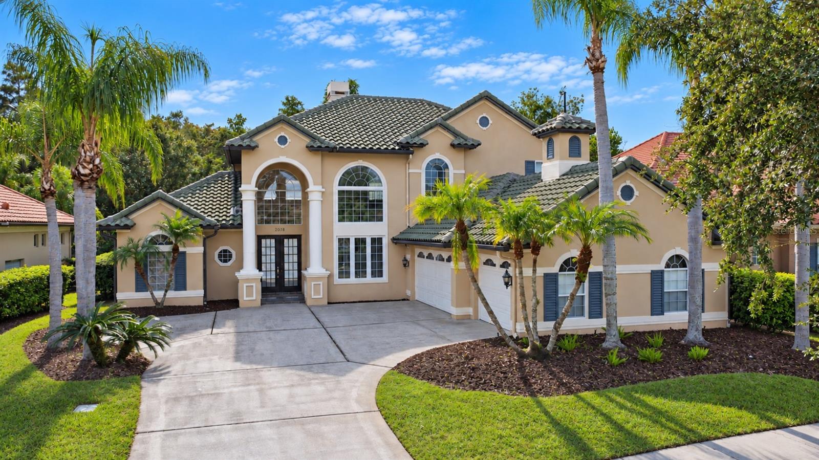 Your search is over! Welcome to an exceptional residence in the prestigious guard-gated community of Stoneybrook East, one of East Orlando’s most sought-after upscale communities. Built by award-winning ADB Development, this impressive home offers an outstanding combination of luxury, spacious living, custom architectural details, and resort-style outdoor living. The spacious open floor plan features the primary suite and a private office/fourth bedroom downstairs, while two additional bedrooms and a large bonus room are located upstairs. The bonus room offers exceptional flexibility and could easily be converted into a fifth bedroom if desired. The home features an abundance of beautiful architectural details, including decorative moldings, elegant tray ceilings, beautiful arches, and custom finishes throughout. The upgraded kitchen features built-in appliances, upgraded cabinetry, and a stunning glass mosaic backsplash. Beautiful wood flooring extends throughout all bedrooms and the entire second floor. The bathrooms feature upgraded designer vanities, while upgraded light fixtures and brushed nickel door hardware add an elegant finishing touch throughout the home. Energy-efficient double-pane windows provide additional comfort and efficiency. Step outside and enjoy your own private resort-style retreat. The beautiful screened-in pool area features a new gas pool and spa heater, perfect for enjoying the pool and spa year-round. The pool also features a saltwater system with a wireless remote for convenient hands-free operation and monitoring. Additional features include two fireplaces: a wood-burning fireplace in the living room and a gas fireplace in the family room, along with a security system featuring emergency backup capability. Stoneybrook East offers an exceptional lifestyle with a 24-hour guard-gated entrance and an impressive selection of community amenities, including a community pool, fitness center, and recreational facilities. The community is also centered around the Stoneybrook East 18-hole golf course, offering a beautiful golf-community setting. HOA dues include cable TV and high-speed internet, adding even more value and convenience to this exceptional community lifestyle. Call today to schedule a private showing!