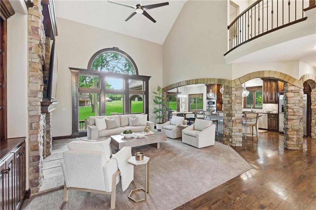 Luxury living tucked back on a quiet, treed, cul-de-sac lot in one of Cedar Creek's most desirable neighborhoods of Shadow Highlands. Walk into this open, main floor living floor plan to find a casual, rustic feel with stone accents and extensive wood trim not found in today's homes. Gorgeous 2-sty stacked stone gas fireplace is flanked by impressive bookshelves. Formal dining room. Kitchen boasts many custom features including a large island, custom granite, 5-burner gas range, SS appliances, eat in dining, & walk in pantry. Main floor master and bath with dbl vanities, 2 shower heads, jacuzzi tub, heated floors, walk in closet & built ins. Main floor laundry includes a sink, folding counter, & multiple cabinets.  Gleaming hardwoods throughout.  Upstairs you will find 2 bedrooms with walk-in closets connected by a Jack & Jill bathroom.  From there, a couple more steps lead you to yet another bedroom with a bird's eye view, walk in closet, and private full bath.  The finished view out lower level allows for additional living and recreational space. Walk behind wet bar has been thoughtfully designed to host many amenities including: sink, disposal, microwave, and under counter fridge. Tucked quietly behind this entertainment area is a 5th bedroom and full bath.  3-car garage is large enough to accommodate a lift and has in the past been turned into a 4-car garage.  Truly a gear head's dream with a heated & air conditioned garage run off a designated mini-split.  You will love the privacy this professionally landscaped lot offers. Serene backyard with a covered stone patio and fire pit allows you to enjoy the deer.