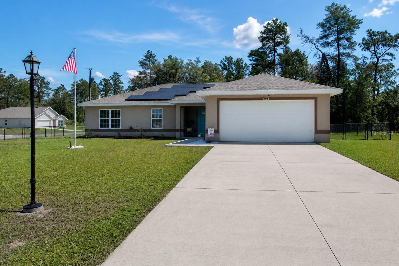 Experience the benefits of newer construction—without the wait, added furnishing costs, oruncertainty—combined with the energy efficiency of the seller-owned 11.725 kW rooftop solar systeminstalled in 2023 and under full warranty, an approx. $45,000 value. This beautifully maintained 2020-built4 Bdrm/2 Bath concrete block home offers 1,752 Sq Ft of comfortable living space and the rare advantageof dramatically reduced electric bills while OWNING your own power source. Designed with modern livingin mind, the open floor plan creates a seamless flow between the living, dining, and kitchen areas, makingthe home ideal for both everyday living and entertaining. Tile flooring extends throughout the main livingareas, while BRAND NEW carpet adds comfort to all four bedrooms. The spacious kitchen features solidwood cabinetry, abundant counter space, and a convenient breakfast bar overlooking the main living area.A desirable split-bedroom layout provides privacy for the owner's suite, while the interior laundry roomadds everyday convenience. Step outside and enjoy Florida living year-round from the expansive 16 x 24covered screened porch, perfect for relaxing, outdoor dining, or gathering with family and friends.Situated on an oversized 0.34-acre corner lot, the property offers exceptional outdoor space, including afully fenced backyard with plenty of room for pets, play, gardening, or future enhancements. Located inMarion Oaks, a deed-restricted community conveniently positioned near major highways, schools,shopping, dining, medical facilities, and the Marion Oaks Community Center, this home offers the perfectbalance of peaceful neighborhood living and easy access to everyday amenities. Whether you're searchingfor a primary residence, retirement home, or simply looking to enjoy the long-term savings and benefits ofsolar ownership, this move-in-ready property delivers outstanding value. Don't miss this opportunity toown a newer home on a large lot with no HOA restrictions. Schedule your showing today and discover justhow affordable Florida solar living can be!