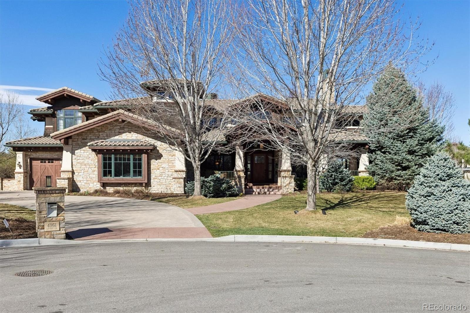Tucked away at the end of a quiet cul-de-sac in the highly sought-after The Preserve at Greenwood Village, this exceptional luxury Craftsman-style residence offers a rare blend of timeless architecture, modern sophistication, and breathtaking mountain views.From the moment you arrive, you’re welcomed by impeccable curb appeal—rich wood accents, stone detailing, and a gracious front porch that sets the tone for the elegance within. Inside, the home unfolds with an open, light-filled floor plan featuring soaring ceilings, wide-plank hardwood floors, and expansive windows that perfectly frame the stunning Front Range vistas. The gourmet chef’s kitchen is the heart of the home, complete with high-end appliances, custom cabinetry, and a generous center island—ideal for both everyday living and entertaining. A cozy yet refined living space anchored by a gorgeous fireplace and soaring ceilings  creates a warm, inviting atmosphere. The upper-level primary suite is a private retreat with its own balcony with exterior fireplace offering serene mountain views, a spa-inspired bath, and a spacious walk-in closet. The other upper bedrooms are generously sized, each with en-suite bath and thoughtfully designed with comfort and privacy in mind. Step outside to a number of decks and a beautifully landscaped backyard oasis, where you can unwind or entertain while enjoying panoramic sunsets over the mountains. Whether gathered around the outdoor living spaces or relaxing in the peaceful surroundings, this home captures Colorado living at its finest. Located within one of Greenwood Village’s premier communities, residents enjoy access to scenic trails both in the neighborhood as well as the highline canal trail, open space, and top-tier amenities—all while being just minutes from shopping, dining, and top-rated schools. This is more than a home—it’s a lifestyle defined by luxury, privacy, and unparalleled natural beauty.