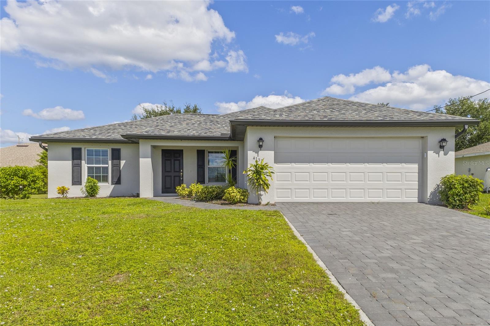 This well-maintained 3-bedroom, 2-bath residence in NE Cape Coral features a 2-car garage, brick paver driveway, and an inviting covered front entry. The bright, open living and dining spaces create a seamless flow for daily living and entertaining. The kitchen is equipped with stainless steel appliances, abundant counter space, and generous cabinetry storage. The primary suite offers a private sanctuary with an ensuite bathroom and spacious closet, accompanied by two guest bedrooms and a full secondary bath. Step outside to a lanai overlooking a large backyard with plenty of room to relax, garden, or build a custom pool. Additional features include an interior laundry room with washer/dryer hookups. Conveniently located near shopping, dining, and local parks—ideal for a primary residence or investment portfolio!