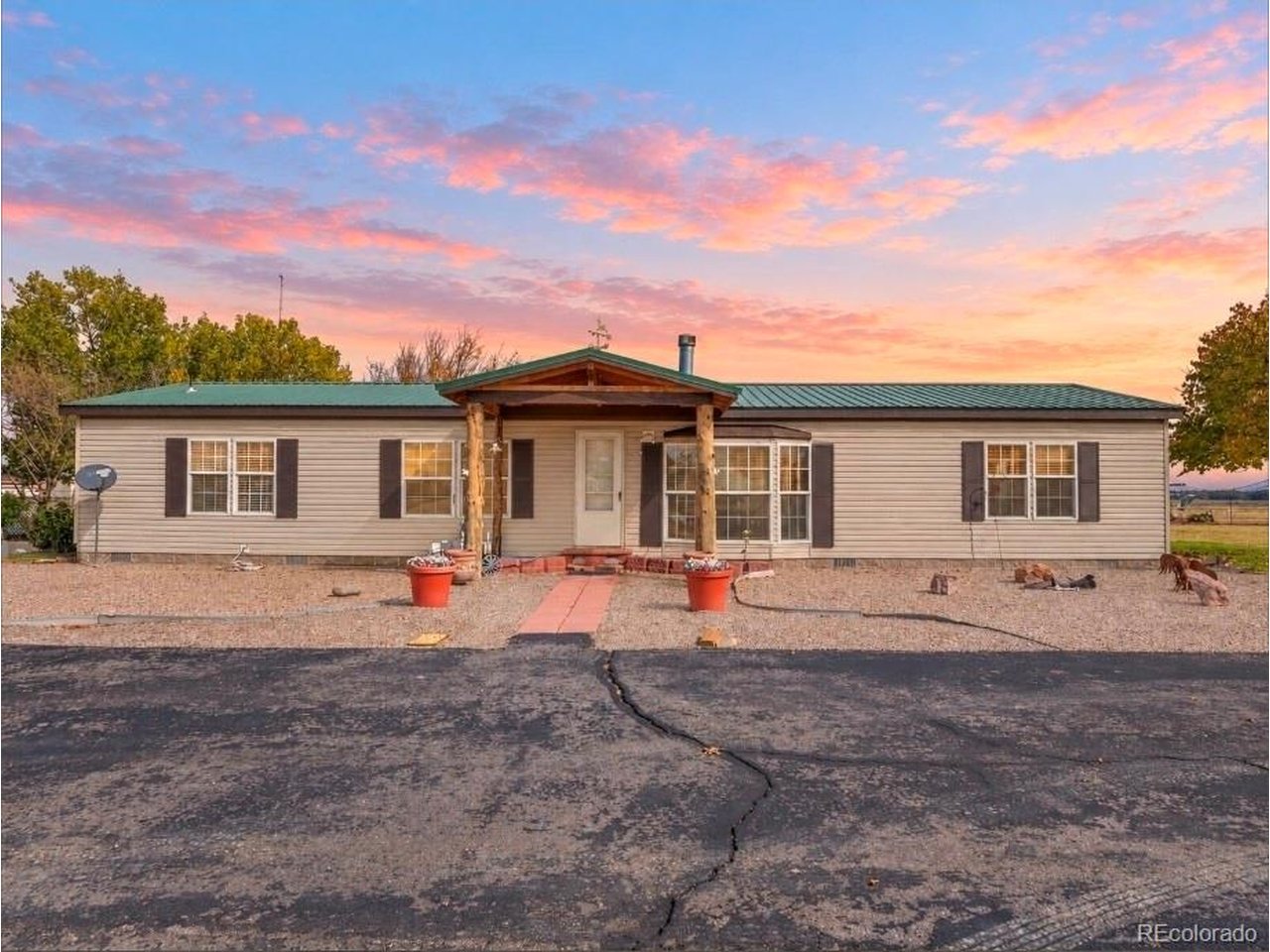 Highway visibility, commercial workspace, and comfortable living come together on this versatile 2.8-acre property at US-50 and Swink Avenue. With C-2 zoning and mixed residential and commercial use, this property offers an opportunity to bring your home and business together in one location. The centerpiece is a 50-by-80-foot insulated metal shop featuring concrete floors, propane heat, three 12-by-14-foot overhead doors, a 26,000-pound lift, 110/220-volt electrical service, commercial lighting, steel shelving, and an included air compressor. A detached two-car garage, 48-foot refrigerated storage trailer, and 50-amp RV hookup add even more functionality. The well-maintained three-bedroom, two-bath modular home offers spacious living and dining areas, walk-in closets in every bedroom, granite kitchen countertops, a copper-plated sink, central air, and a wood-burning fireplace. A metal roof adds durability, while the expansive 29-by-21-foot covered patio-with ceiling fans, lighting, and a hot tub-creates an inviting space to unwind. Fruit trees, grapevines, raised garden beds, and a backyard water feature provide a peaceful retreat alongside the property's substantial workspace. Explore the possibilities of this distinctive property with room to live, work, and grow. Buyer to verify zoning and permitted uses for their intended business.