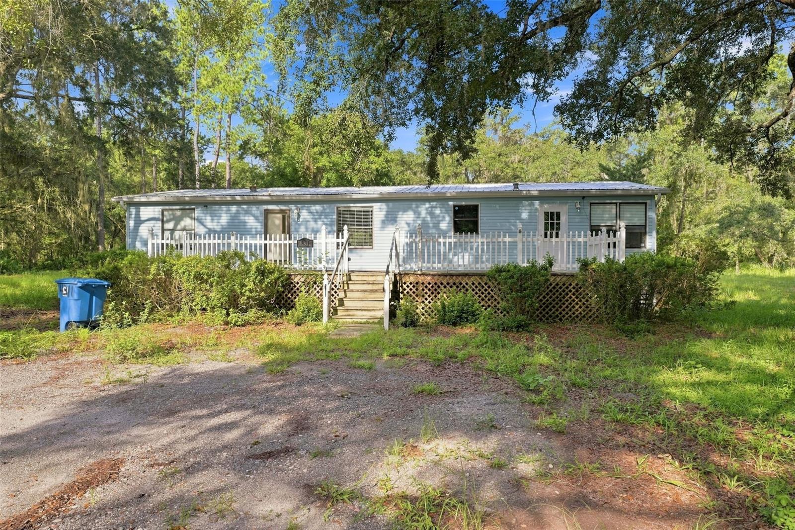 Five acres, AG zoning, no HOA, and room to spread out and make it your own. Welcome to 4311 Culbreath Road in Brooksville, where mature trees, open spaces, and a peaceful country setting create the kind of property that is getting harder to find. Set on 5 acres of AG-zoned land, this property offers a combination of privacy and usable space, with established trees providing shade and character throughout the property. Whether you have been searching for additional outdoor space, room for equipment, gardening, hobbies, or simply more breathing room, there is plenty of space here to create a property that fits your needs. The 3-bedroom, 2-bath manufactured home offers 1,512 square feet of heated living space with a split-bedroom floor plan. Inside, you will find a spacious living area highlighted by a fireplace, a kitchen with abundant cabinetry and counter space, and a primary suite featuring dual sinks, a soaking tub, and separate shower. Outside, the property includes an existing shed/outbuilding, ample space for parking and projects, and a mix of cleared and wooded areas offering flexibility for a variety of uses. The home is served by well and septic, and there are no association fees. Adding even more potential, the property is grandfathered with Hernando County for the ability to add a second dwelling, with the grandfathered status currently extending through May 2027. Buyers should independently verify applicable requirements, permitting, and deadlines with Hernando County. The existing home provides an opportunity for a new owner to bring their own vision and make improvements over time, while the acreage and existing improvements provide a great starting point. If you have been looking for a Brooksville property with five acres, privacy, flexibility, and room to make it your own, schedule your showing today.