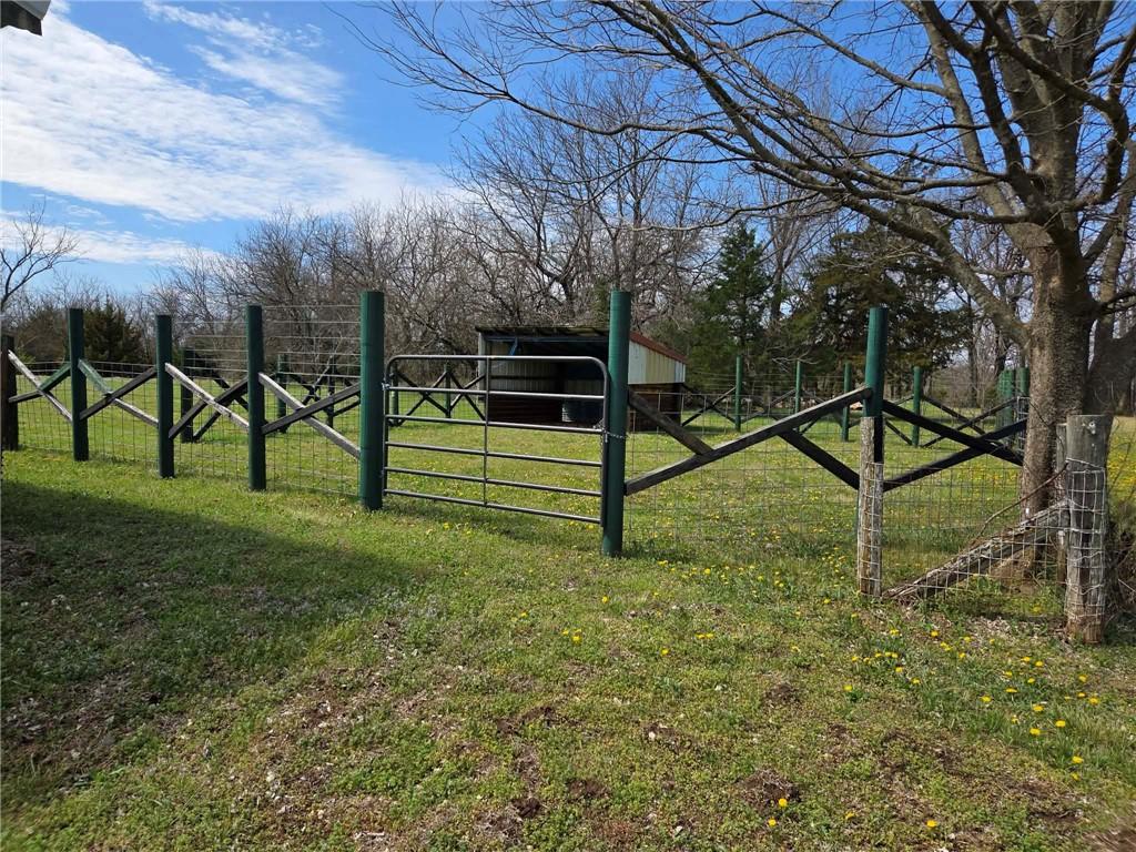 Looking for a private retreat with multiple facets for your living space, recreation, hunting, livestock and , then call us today.  Perimeter fence on 3 sides (not on N), large pond, small pond, wildlife including quail, dove, turkey, deer.  Two hunting shelters (4x8 and 5x8).  40x28 shop with wood heat, chicken coop, detached garage and other sheds.  3 BR/2 bath home (mobile home with on-site construction addition).  All on 50 acres, M/L.  Some personal property to remain at no additional cost include 16' winch system, water tank, Hustler zero turn mower. Property sold AS IS.