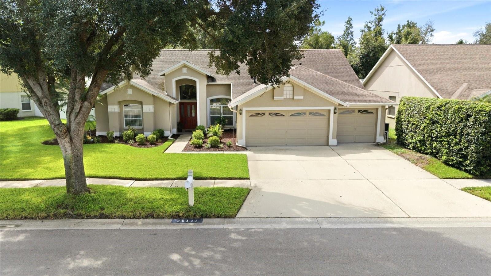 Virtually Staged. Welcome home to this meticulously maintained and beautifully presented residence in the highly sought-after community of Meadow Pointe! From the moment you arrive, you'll be captivated by the impeccably manicured landscaping, oversized three-car garage, and stunning curb appeal that sets the stage for everything this exceptional home has to offer. Step through the formal foyer into a light-filled living room where soaring ceilings and expansive triple sliding glass doors showcase views of the oversized screened lanai and lush, fully fenced backyard. Privately situated, the spacious owner's retreat features vaulted ceilings, dual walk-in closets, and a luxurious en suite bath complete with split vanities, a relaxing garden tub, and a separate walk-in shower. The large formal living space is the perfect option for a good book or just enjoying those stunning backyard views! Designed for both everyday living and entertaining, the heart of the home is the beautifully appointed kitchen featuring a built-in oven, brand-new cooktop, abundant counter space, center island, and a breakfast bar overlooking the sunny dining area with easy access to that generous covered and screened lanai for seamless entertaining! Even the largest gatherings will enjoy spreading out in this backyard oasis! Just off the kitchen, the adjoining family room is warm and inviting with dramatic cathedral ceilings and a charming decorative corner fireplace, creating the perfect gathering space for family and friends. This thoughtfully designed triple-split floor plan offers five spacious bedrooms and three full baths. The private fifth bedroom, located just off the family room, enjoys its own full bath, making it ideal for guests or extended family.  Three additional guest bedrooms are positioned toward the front of the home and share a generously sized shared bathroom. Now, lets step outside to your own private oasis where the expansive covered and screened lanai overlooks nearly a quarter-acre of lush tropical landscaping within the fully fenced backyard. Whether you're hosting weekend barbecues, enjoying your morning coffee, or simply relaxing in the Florida sunshine, this outdoor living space is truly exceptional. A storage shed provides additional space for tools, lawn equipment, or hobbies. Recent updates include luxury vinyl plank flooring, brand-new carpet, fresh interior and exterior paint, a 2017 HVAC system, a 2021 roof, and a 2022 water heater, giving buyers peace of mind with all the major improvements are already completed. Community amenities include 2 community pools, 2 playgrounds, waterpark, fitness center, racquetball, pickleball, tennis and volleyball! So, cancel that gym membership, you've got an entire active lifestyle waiting for you here with NO HOA! Perfectly blending generous living spaces, thoughtful updates, and an outstanding layout, this Meadow Pointe gem is ready to welcome its next owners. Schedule your private showing today and experience everything this spectacular home has to offer!