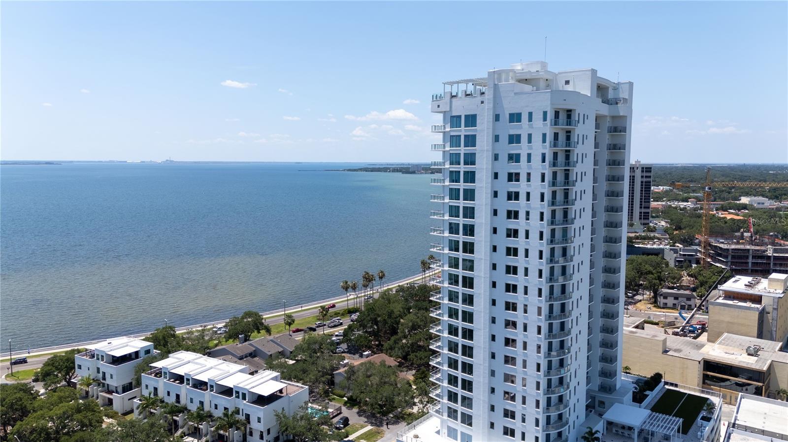 Welcome to elevated living at Altura Bayshore, one of Tampa’s newest and most prestigious luxury high-rise residences. Ideally positioned just moments from world-famous Bayshore Boulevard and the city’s premier shopping and dining destinations, this exquisite residence offers a refined blend of modern elegance, comfort, and breathtaking waterfront views.Unit #1902 showcases a thoughtfully designed interior characterized by wide-plank wood flooring, custom built-in closets, and floor-to-ceiling windows and sliding glass doors that flood the home with natural light while framing outstanding water views. Step onto your private balcony to enjoy sweeping vistas and unforgettable sunrises and sunsets over Tampa Bay.The chef’s kitchen is a true showpiece, featuring sleek cabinetry, premium appliances, an integrated wine refrigerator, and elegant finishes ideal for both everyday living and upscale entertaining. The open-concept layout seamlessly connects the kitchen, dining, and living spaces, creating an inviting atmosphere that is both sophisticated and functional.Altura Bayshore delivers a resort-style lifestyle with an exceptional suite of amenities, including 24/7 security, a rooftop pool with expansive outdoor entertaining spaces, pickleball and basketball courts, and a state-of-the-art fitness center. Every detail has been curated to meet the expectations of the most discerning buyer.This is luxury urban living at its finest — where panoramic water views, refined interiors, and an unparalleled South Tampa location come together in one extraordinary residence.