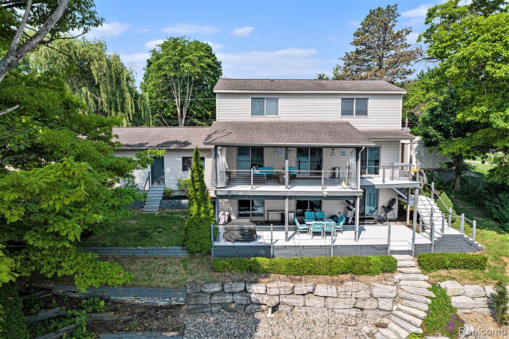 Welcome to this stunning 4-bedroom, 3.5-bathroom home perfectly nestled on the shores of beautiful Lobdell Lake. Thoughtfully designed with comfort and functionality in mind, this property offers an exceptional blend of spacious living and breathtaking views. The main level features a bright, open-concept living area ideal for entertaining, anchored by a modern kitchen with a large pantry, generous counter space, and abundant storage, beautiful wood floors, granite counter tops and tons of natural light. The primary suite is conveniently located on the main floor, complete with a private bath and large closet. On the second floor there are three large bedrooms and a full bathroom with a jetted tub, double sink, and standing shower. Downstairs, the finished walkout basement provides a versatile space for guests or recreation, including a kitchen, large family room, full bathroom, and flexible space perfect for a home office, gym, or game room. Step outside to enjoy two covered decks, where you can relax and soak in the serene lake views year-round. The expansive 3-car garage includes a large mudroom for added convenience, while the property’s extra parking and shed offer rare and valuable storage options. With large closets throughout and thoughtful extras like ample storage space and a peaceful setting, this one-of-a-kind lakefront home is the perfect retreat for both everyday living and weekend getaways.