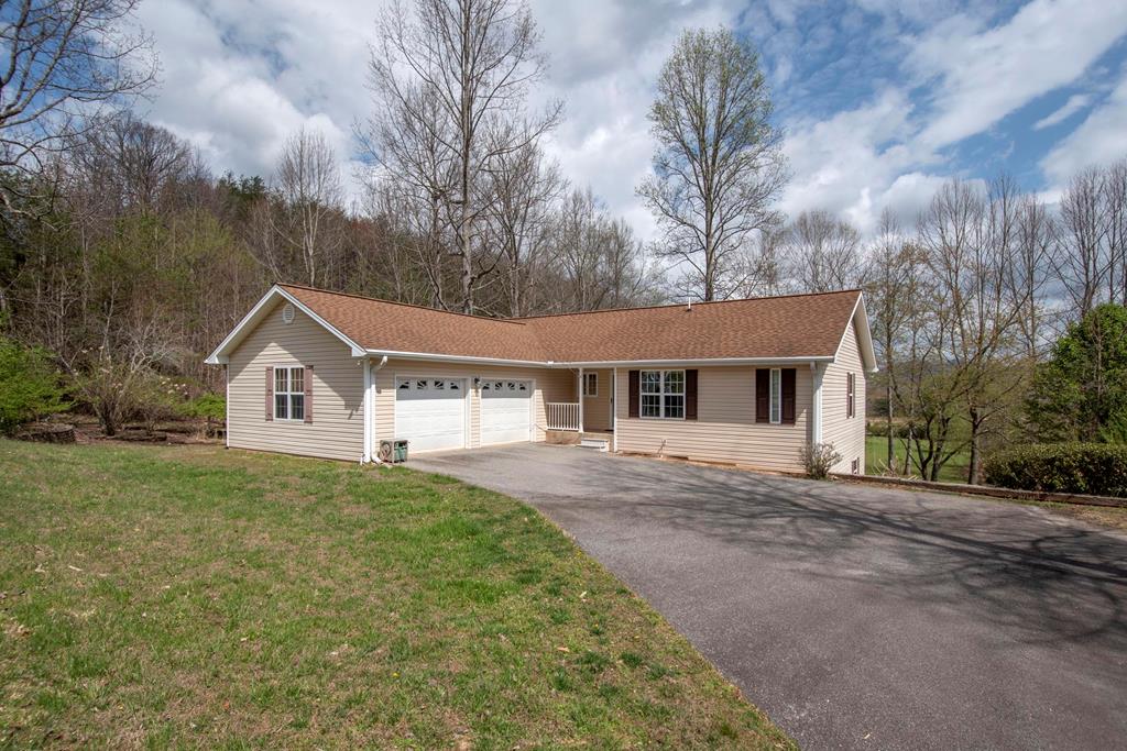 Charming 3-bedroom, 3-bath home with primary suite, laundry room, 2nd bedroom or office, and 2 full baths on the main level! Enjoy cozy evenings by the gas fireplace and relaxing mornings on the screened-in porch overlooking picturesque, gently sloping landscape. The main level offers comfortable living, while the lower level features a great room, guest bedroom and spacious den (or 2bedrooms) and a full bath, perfect for visitors or additional living space. This home also includes a 2-car garage on the main level, plus an additional 1-car sized garage down below, providing plenty of room for a workshop, hobbies, storage, and gardening equipment. Ideally located between Hiawassee and Blairsville, close to shopping and outdoor activities, this property offers the best of mountain living in beautiful North Georgia. Priced to sell, don't miss this opportunity!