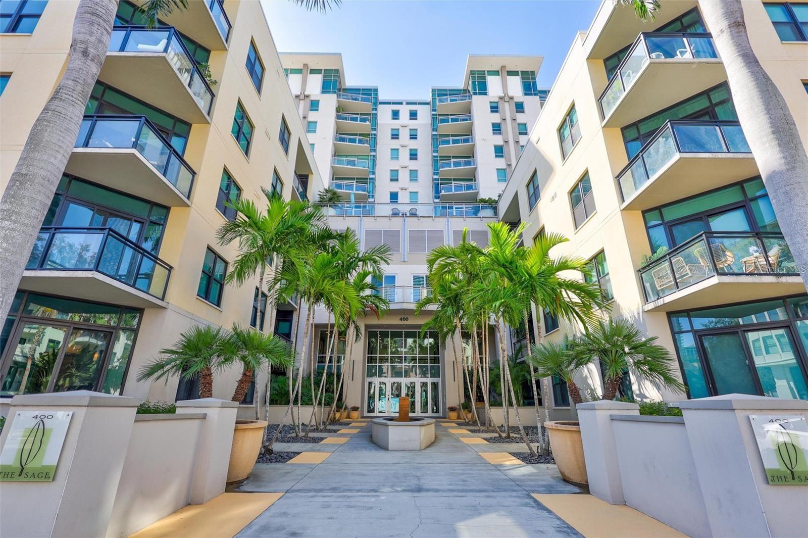 Prepare to be wowed the moment you step inside this stunning 10th-floor designer retreat at The Sage, perfectly positioned in the heart of vibrant Downtown St. Petersburg. In addition to its spacious bedrooms, the residence features a versatile bonus room, offering the perfect space for a private home office, additional storage, or a flexible area tailored to your lifestyle. Thoughtfully upgraded and beautifully appointed, this residence combines sophisticated style, an open and airy layout, and spectacular views to create an exceptional downtown living experience.The open-concept floor plan is framed by dramatic floor-to-ceiling windows, filling the home with natural light while showcasing breathtaking views of the downtown skyline and partial water views. Step outside onto your private balcony and take in the city from above—an incredible setting for morning coffee, evening cocktails, or simply enjoying the energy of downtown from the comfort of home. With its desirable south-facing orientation,  the residence enjoys beautiful natural light while limiting direct sun exposure.Inside, hardwood flooring, fresh interior paint, designer finishes, and gorgeous upgrades create a polished yet inviting atmosphere. The split-bedroom floor plan provides added privacy and flexibility, making it ideal for guests, a home office, or a second bedroom. For added convenience, the owner is willing to build out a closet in the second bedroom or provide the buyer with a credit toward the closet build-out, allowing the new owner to customize the space to suit their needs.The beautifully maintained Sage building offers sought-after amenities, including a fitness center and community pool, providing the perfect balance of comfort, convenience, and resort-style living.And then there’s the location. Situated in the heart of Downtown St. Pete, you’ll be surrounded by everything that makes this city such an incredible place to call home—from acclaimed restaurants, cafés and nightlife to waterfront parks, museums, galleries, shopping, entertainment, and the vibrant St. Pete waterfront.Designer style, incredible views, desirable amenities, and an unbeatable downtown location—this 10th-floor residence offers the elevated St. Petersburg lifestyle you’ve been waiting for.