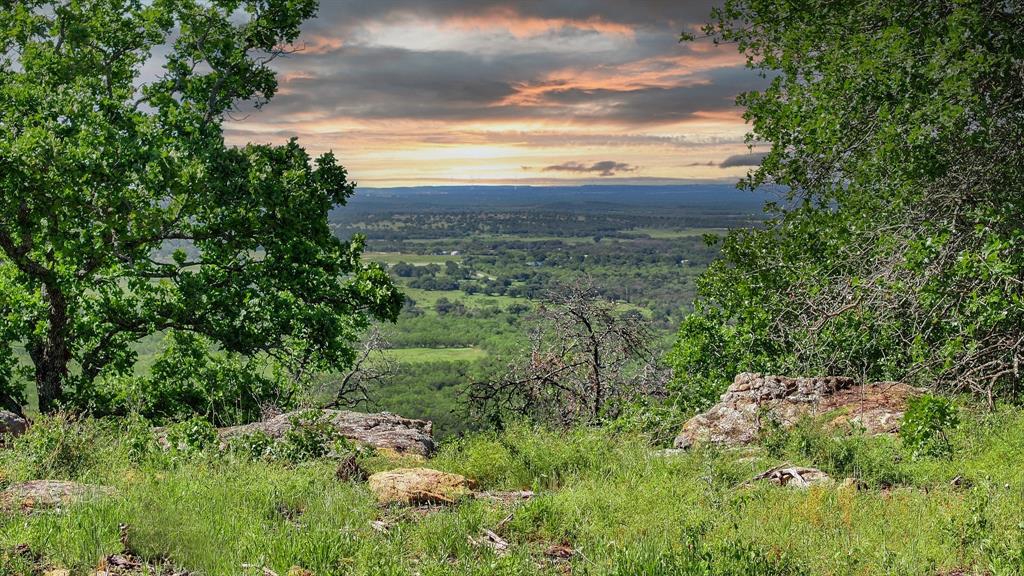 The Ranches at Clayton Mountain offer breathtaking views in every direction from over 1200' elevation. These properties offer an ideal mix of Texas Oak, Blackjack Oak, Live Oak, Elm and a small amount of Mesquite for your smoker. Inside the custom-built entrance, the Ranches have plentiful whitetail deer, rio grande turkey, dove, varmints and an impressive free-ranging aoudad herd. Perfectly located two miles north of Interstate 20 in Palo Pinto County, this propety is adjacent to the exclusive 7R Ranch and Equestrian Center, 15 min from the famous Mary's Cafe in historic Strawn and less than one hour from the Metroplex. Come build the weekend getaway or retirement home of your dreams!