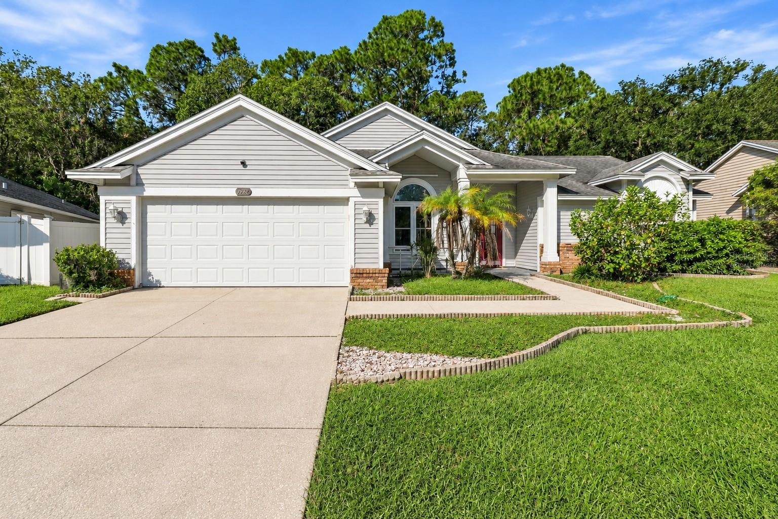 Exterior listing photograph: Pool Home with a Wooded View in New Port Richey