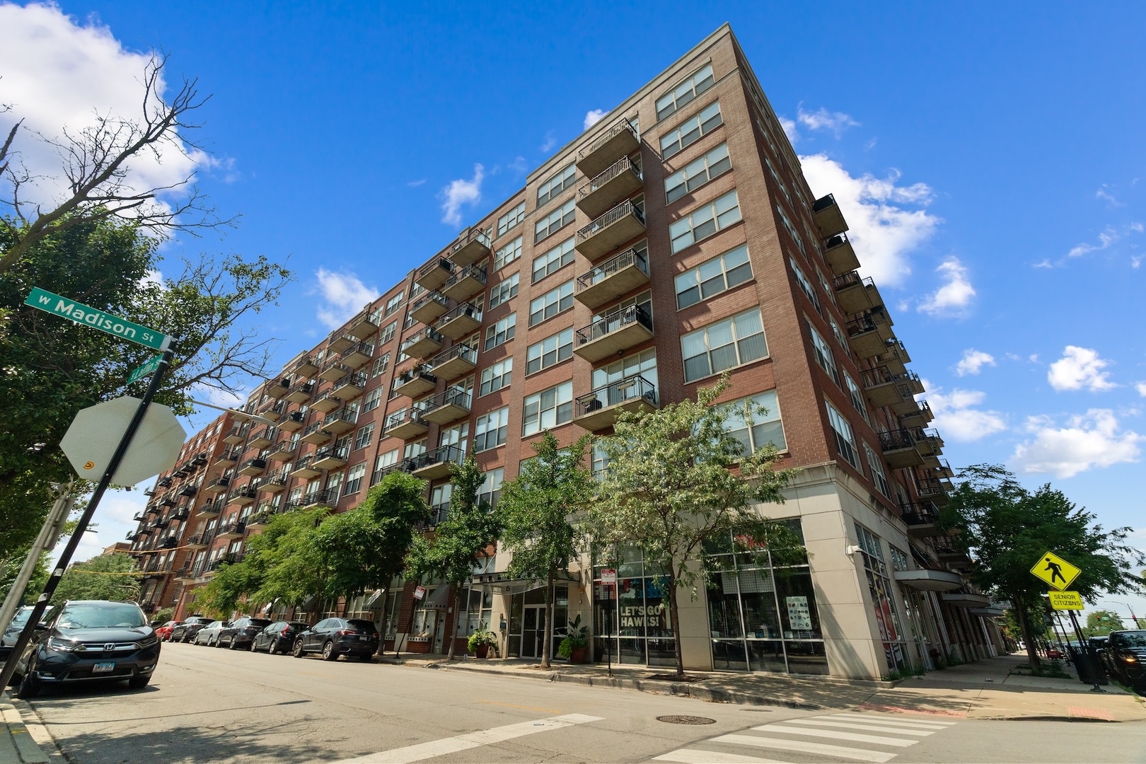 Rare 2-Story Penthouse Loft with Private Rooftop Deck & East-Facing Skyline Views!  This well-maintained 3 bed, 3 bath concrete loft penthouse in the heart of the West Loop/Skinner School District offers the perfect blend of space, light, and flexibility. The open-concept main level features floor-to-ceiling east-facing windows, a cozy gas fireplace, and balcony access for taking in the city views. The kitchen boasts granite counters, stainless steel appliances-including a brand-new fridge-and ample cabinet space, plus a pantry and coat closet. A full bath with walk-in shower and a versatile third bedroom/office complete the main floor.  Upstairs, the spacious primary suite includes a walk-in closet, double vanity, and jet tub, with sliding doors leading directly to your private rooftop deck with stunning panoramic views. An additional bedroom with deck access, full bath, and storage closet are also on the upper level.  Additional highlights include oak hardwood floors throughout, high concrete ceilings, ceiling fans, in-unit laundry, a new furnace (2024), and a private 2-car enclosed garage within the building. Elevator building with door staff, bike room, storage, and pet-friendly policies.  Ideally located near multiple transit lines, I-290, the Medical District, Whitney Young HS, Skinner Park, and the vibrant Madison Street corridor filled with top dining, shopping, and entertainment options.  Note: Property was tax-exempt through 2024 due to previous church ownership.