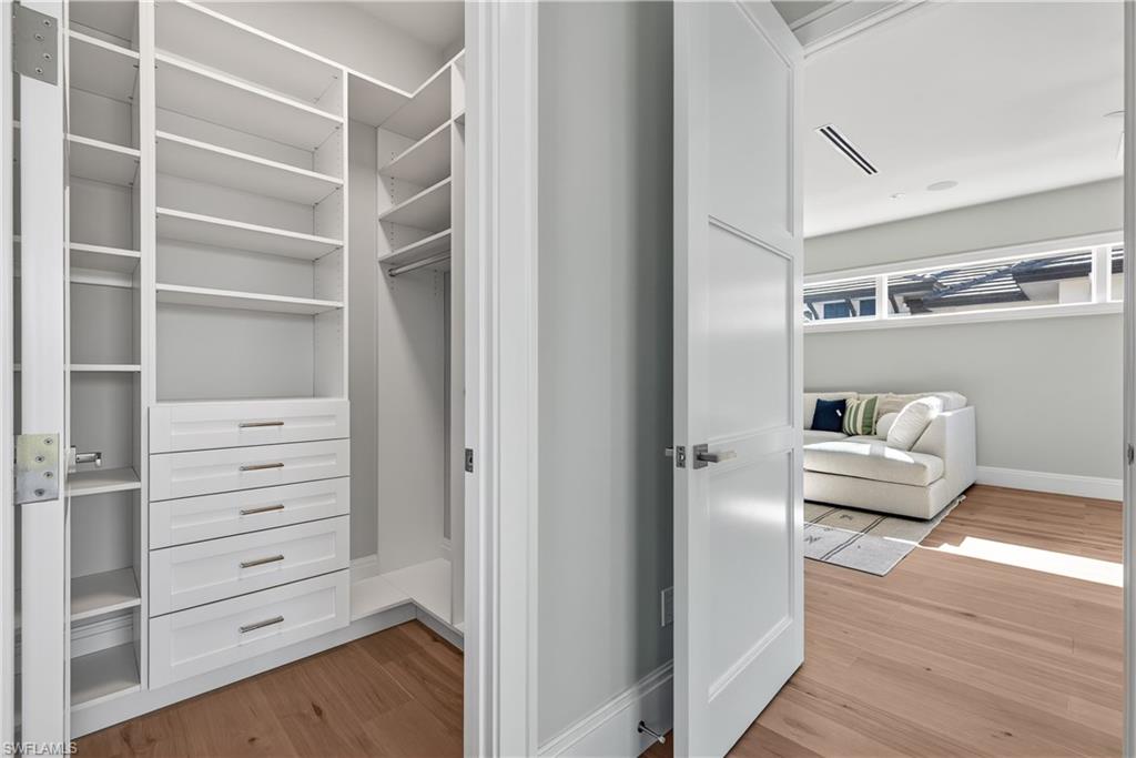 Walk in closet featuring light wood-type flooring