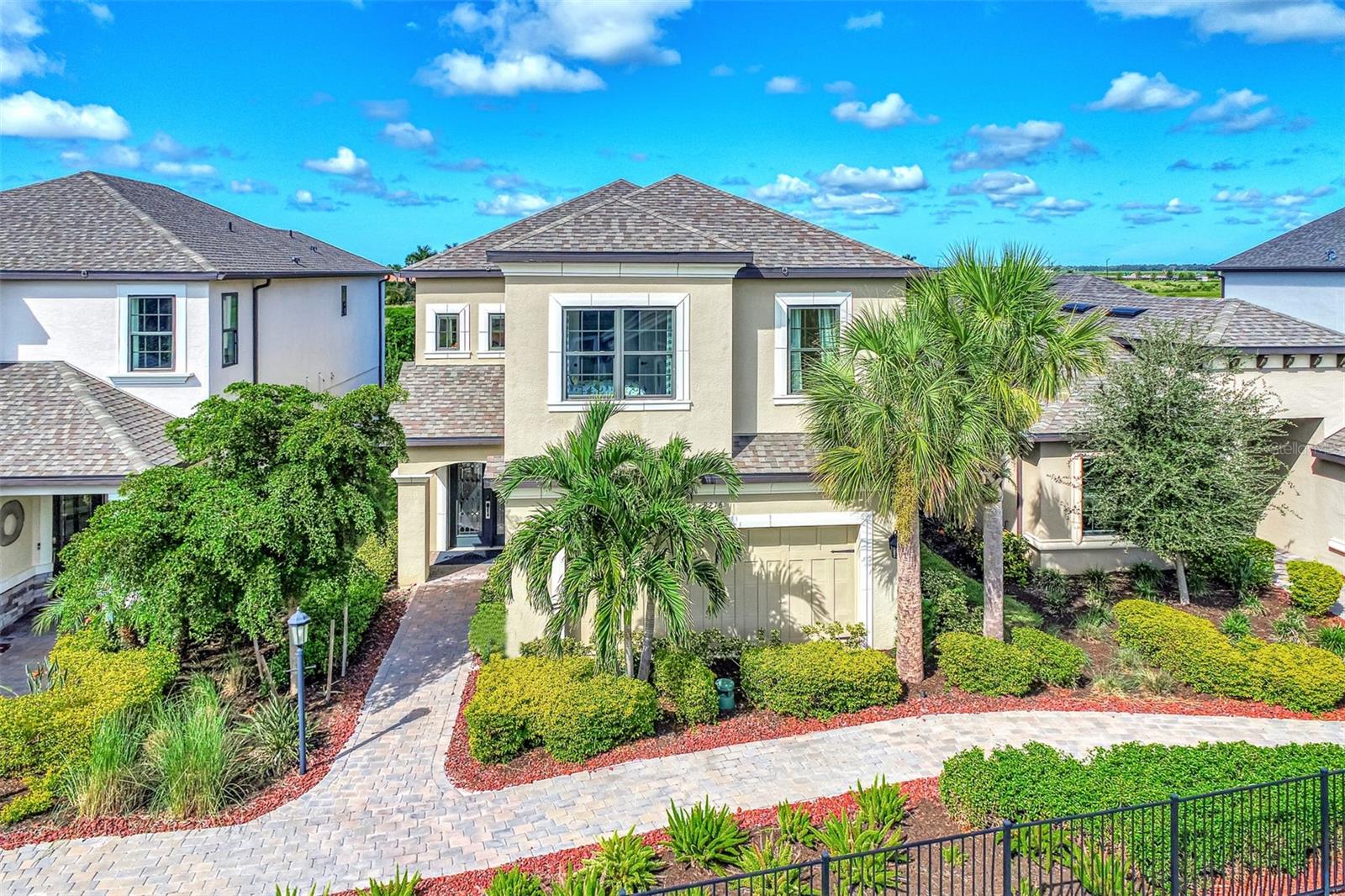 Welcome to an extraordinary opportunity to own a magnificent model home located in the exclusive Skye Ranch community of Sarasota, FL. This stunning residence spans an impressive 3,207 square feet and boasts a thoughtfully designed layout featuring four generously sized bedrooms and two and a half elegant bathrooms. Every corner of this home is adorned with exquisite high-end finishes, epitomizing luxury and sophistication.

Upon entering, you are greeted by a gourmet kitchen that serves as the heart of the home. It is equipped with sleek quartz countertops and a striking glass backsplash that adds a touch of modern elegance. The kitchen's functional design is perfect for both everyday cooking and hosting lavish dinner parties. Complementing this space is the meticulously planned lighting scheme, which includes recessed lights that enhance the ambiance and highlight the architectural details, such as the beautifully crafted wood crown molding found throughout the home.

The open-concept layout seamlessly connects the indoor and outdoor living spaces, creating an ideal environment for entertaining guests or enjoying tranquil family moments. Step outside into a personal oasis where a private pool awaits, surrounded by a screened lanai that offers shade and comfort. Adjacent to the pool, a charming brick fire pit area provides a perfect setting for cozy gatherings under the starlit Florida sky.

Adding to the home's convenience is an attached garage, providing ample storage and protection for vehicles, as well as laundry facilities that enhance daily living. The Skye Ranch community itself offers a wealth of amenities, ensuring a lifestyle of comfort and leisure. Residents have access to a state-of-the-art fitness gym, beautifully landscaped common outdoor spaces, a well-equipped playground, tennis courts, and a community pool, providing endless opportunities for recreation and relaxation.

The home is equipped with impact glass windows and doors, providing peace of mind with enhanced security and energy efficiency. Strategically located, this property offers easy access to I-75, making travel convenient, and places you within proximity to the stunning Siesta Key Beach, renowned for its pristine sands and clear waters. An array of shopping and dining options are also nearby, allowing for an enriched lifestyle filled with convenience and choice.

This exceptional home is more than just a place to live; it is an invitation to experience unparalleled luxury and comfort. Don’t let this opportunity pass you by. Schedule a showing today and step into a world of elegance and distinction.