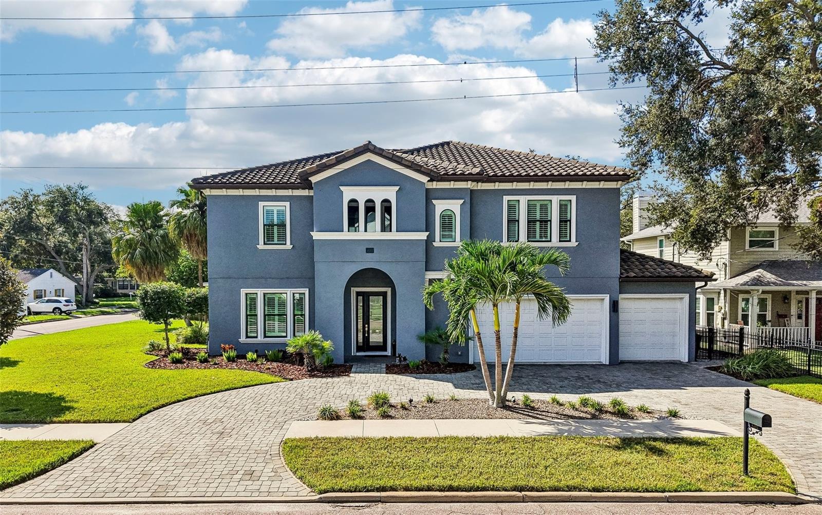 Perfectly positioned on a 100-by-100-foot corner lot in coveted Virginia Park, this beautifully appointed custom-built Mobley five-bedroom, 4.5-bath home offers exceptional features, including a first-floor private suite perfect for multigenerational living. Zoned for the highly sought-after Mabry, Coleman and Plant school districts, the residence features a pavered circular drive with abundant parking, tile roof and an impressive three-car garage with a pull-through bay leading to a dedicated concrete pad with 30-amp power—ideal for a boat, RV or other recreational vehicle. The first-floor suite features its own private exterior entrance and en-suite bath with an easy-entry shower and grab bars, offering both privacy and convenience for guests, relatives or even a separate home office. Meticulously designed and maintained by its original owners, the home is loaded with upgrades and extras, with no detail overlooked.Inside, the home strikes a comfortable balance between refined finishes and everyday livability. The open and airy main level flows effortlessly from the formal dining room into the expansive kitchen and adjoining living spaces, with rich hardwood flooring, crown molding and plantation shutters adding a polished touch throughout. At the heart of the kitchen, an oversized quartz island provides generous workspace and casual seating, complemented by rich 42-inch espresso cabinetry, a beautiful tile backsplash and an induction cooktop beneath a sleek range hood. The cooktop/range area is also PLUMBED FOR GAS, providing the flexibility for an easy conversion to a gas range if desired. A thoughtfully designed butler’s pantry with beverage refrigerator extends the kitchen’s functionality, while the charming nook just beyond it offers a natural spot for a home office, homework station or pet area. The home’s heat and hot water heater are POWERED BY NATURAL GAS, adding to its efficiency and convenience.Upstairs, a spacious loft adds another gathering or flex space, while four bedrooms provide an unusual level of privacy, with every bedroom offering a walk-in closet and en-suite bath. The primary suite is a peaceful retreat beneath a tray ceiling, with dual vanities, a freestanding soaking tub, frameless-glass walk-in shower and two walk-in closets, including one with custom organization. The upper-level laundry room is equipped with a sink and built-in storage, keeping everyday tasks conveniently out of sight. From abundant closets and nooks to an extra storage area within the three-car garage and a spacious backyard shed, this home offers unparalleled storage, with no need to compromise.With its highly desirable South Tampa location, highly regarded school district, oversized corner lot, versatile floor plan and exceptional garage and parking accommodations, this one-of-a-kind home offers a rare combination of lifestyle and functionality in one of the area’s most desirable neighborhoods.