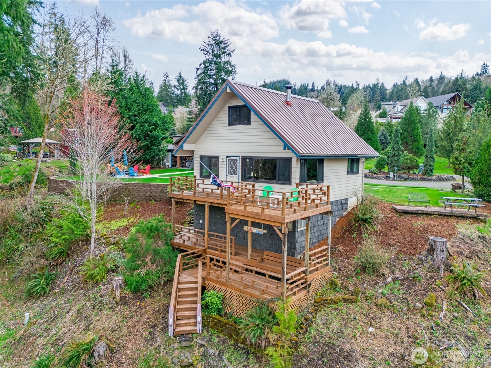 Discover endless possibilities of this exceptional lakefront estate where there's plenty of room for everyone. With an ADU & full RV hookups, situated on nearly an acre of prime land, this is one of only a dozen homes lakefront on Mayfield Lake! This property offers breathtaking views & a paid-in-full marina membership through 2025 ($1,700/year) including a personal boat slip. Enjoy entertaining w/ a two-tier deck, fire pit & hot tub. The remodeled ADU features a spacious living area, 2 additional bedrooms, sleeping loft, full kitchen & a bathroom w/ laundry. This home is move-in ready & comes fully furnished, allowing you to start enjoying lake life the day you close. On four sub-dividable lots (buyer to verify) w/ plans for a larger home.