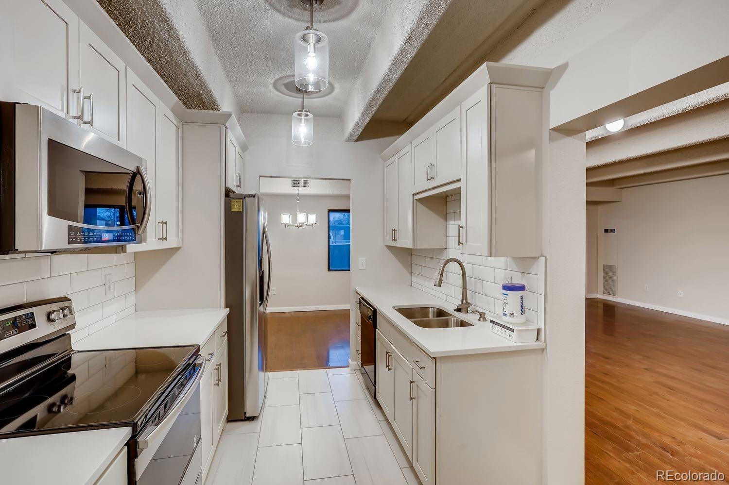 Experience the ideal combination of comfort, convenience, and resort-style amenities in this spacious 2-bedroom, 2-bath condo located in the sought-after Candlewyck community. Designed with an open-concept layout and filled with natural light, this inviting home seamlessly connects the living room, wet bar, dining area, and kitchen, creating an expansive, welcoming atmosphere.

Step into your private enclosed lanai, adding approximately 200 extra square feet of year-round enjoyment or unwind in the peaceful primary suite featuring generous closet space and a private ensuite bath. The unit boasts stylish laminate and tile flooring throughout.

Included with the condo are two parking options: an assigned underground garage space (#85) and an upper-deck outdoor spot (#112). Residents enjoy access to unmatched community amenities, including a spacious clubhouse with kitchen, swimming pool, hot tub, steam room, sauna, fully equipped fitness center, tennis court, four pickleball courts, ping pong and billiards rooms, outdoor grilling stations with seating areas, tranquil walking paths, two picturesque ponds with waterfalls, a library, and a craft room.

With gated security and on-site management, peace of mind is built in. Ideally situated along the scenic Highline Canal and just minutes from premier shopping, dining, and major destinations including downtown Denver, Cherry Creek North, and the CU Anschutz Medical Campus—this is low-maintenance, high-comfort urban living at its best.