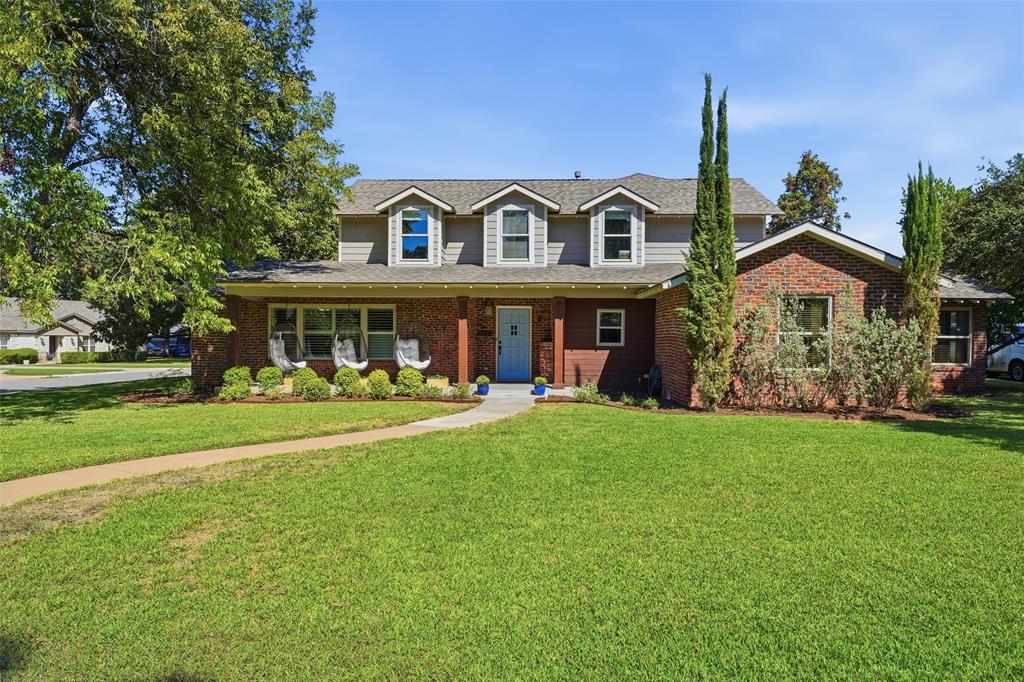 Welcome to 3712 Brighton, where 1948 charm meets the right updates so you can skip the old-house worries. Fresh landscaping, a clinker brick exterior, and a beautiful corner lot in Westcliff West set the tone, and the swing chairs on the front porch were made for morning coffee. You're minutes from TCU and the best of Fort Worth, yet tucked away on a peaceful tree-lined street. Inside, the living room is full of natural light with hardwood floors, plantation shutters, and a wood-burning fireplace. The dining room stuns with corner built-ins and picture frame molding, and the kitchen is where everyone ends up gathering, with a big center island, gas cooktop, double ovens, a farmhouse sink, tons of cabinet space, and a large walk-in pantry. Just past it, the sunroom opens through a wall of glass doors to the covered deck, so your office, playroom, or reading spot comes with a backyard view. The primary bedroom is downstairs, and the second downstairs bedroom has a built-in Murphy bed, so it's a home office Monday through Friday and a guest room when family comes to town. Upstairs, a huge second living area with a built-in media wall and large closets gives the kids their own hangout and room to spread out. Two upstairs bedrooms, each with double walk-in closets, share a Jack and Jill bath with private sink areas. Elfa closet systems and built-ins run throughout, including a laundry room with a sink and storage surrounding the washer and dryer, plus a mudroom drop zone with cubbies for backpacks and shoes. Outside, the gated driveway leads to a 2-car garage and a fully fenced yard with room to play. The 2014 addition brought the second floor, sunroom, laundry, garage, all new electrical, HVAC, and a tankless water heater. Recent updates include a new roof (2024), exterior paint, a sewer line repair, a new water service line, and fresh interior paint. You get the character you can't build new, without the projects that usually come with it. Come see it for yourself!