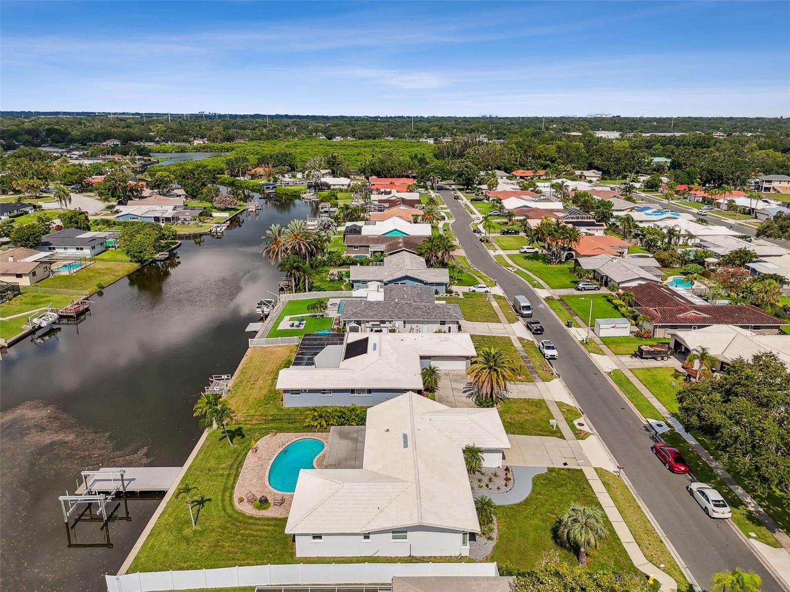 Welcome to this MAGNIFICENT Water front Executive Home. A 4bedroom 2bathroom 2car garage with your own private Saltwater Dock and Exclusive waterway that leads to Tampa Bay and the Gulf of America featuring World Class Fishing right out your backdoor! This is Florida living at its finest, located six miles from world famous Clearwater Beach, featuring the finest beaches, dining and entertainment in the World. Situated on sought after Allen's Creek featuring  85 acres of Nature preserve, protected mangrove and  bird sanctuary. Watch the eagle's dive for fish , watch dolphin and manatee play at your dock on the regular.  Experience incredible Sunrises and Sunsets and Million Dollar Water Views everyday. You will enjoy an open and airy floor plan with  the all  New Chefs kitchen, Quartz countertops,  solid wood cabinets, and modern lighting that compliments the natural lighting in the home thru the beautiful hurricane rated sliding glass doors and windows. Your incredible Master suite boasts a private en-suite that leads to the pool with custom Marble walk-in shower and Cedar vanity. Huge his and her Custom built-in walk-in closet. This split plan has a huge living room with plantation shutters, family/dinning combo with Island bar seating and Three  generous Additional  Bedrooms  on the other side  of the house! You will also find another recently Updated Bathroom with Exotic Granite, a attached Oversized Two car garage and inside laundry room with wash tub. Your Nautical Fantasy awaits out the backdoor of this charming home. Step into your future with a backyard Oasis, private Pool, pass thru Quartz patio Bar, lush large Yard, 10,000lb Boat Lift and Custom built composite dock for your boating, fishing and kayaking pleasure. The inviting pool and Patio area is perfect for year-around Outdoor Entertaining, making this home the Premium Florida Lifestyle! Centrally located approximately  10 minutes from St  Pete airport and 20 minutes from Tampa International. Just 2 miles or so to incredible Eagle lake park for picnicking, biking, tennis, fishing, dog parks for all sizes and 5 miles of walking trails. Don't miss this incredible opportunity to live the dream!