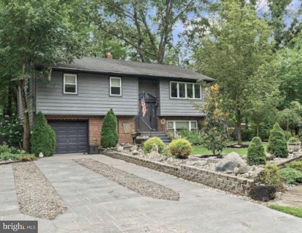 Welcome to 112 Woodland Ave in the heart of Medford, offering space, privacy, and access to one of the area’s most desirable lake communities.This 5-bedroom, 2-full-bath home sits on a beautiful wooded lot and features new flooring throughout and a recently updated bathroom, blending modern touches with warm, comfortable living. The layout provides both upstairs and downstairs living areas, giving you flexibility for entertaining, working from home, guests, or multi-generational living.Large windows fill the home with natural light and showcase peaceful views of the surrounding trees, creating a calm, retreat-like feel in every season.Step outside to your own backyard oasis featuring a deck with hot tub, perfect for relaxing at the end of the day. The property also includes multiple sheds for exceptional storage, hobbies, or workshop space.As an added bonus, this home includes access to the Lake Pine Colony Club, giving you the opportunity to enjoy lake life, community events, and outdoor recreation just moments from your front door.Tucked away in a serene setting yet conveniently located near Medford Village shops, dining, and schools, this home offers the perfect balance of nature, space, and convenience.If you’ve been looking for room to spread out while still enjoying the benefits of community living, 112 Woodland Ave delivers.