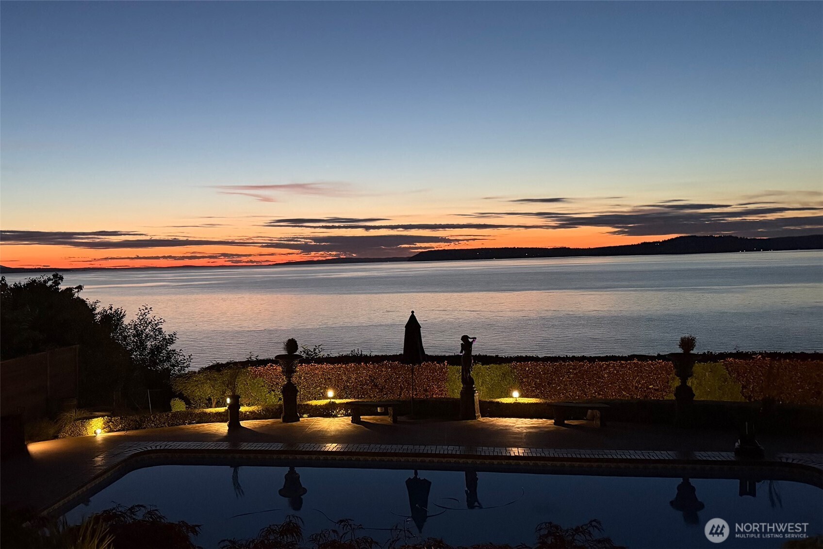 Welcome to your own private waterfront resort, where every day begins with sparkling views of Puget Sound and ends with unforgettable sunsets over the Olympic Mountains. Whether you're hosting friends around the pool, enjoying dinner on the patio, or unwinding with a margarita as the sky turns shades of orange and pink, this is a home designed to be lived in and enjoyed.A gracious circular drive welcomes guests to this beautifully renovated waterfront home, where timeless craftsmanship meets relaxed Northwest living. This residence has been meticulously renovated in 2008 with uncompromising attention to detail, elevating it for today’s living. Designed with the ease of main-floor living, it offers exceptional comfort along with beautifully appointed spaces for entertaining. The chef's kitchen showcases custom stonework, granite surfaces, and premium finishes, while luxurious bathrooms, a private media room, and a temperature-controlled wine cellar elevate everyday living.Step outside to impeccably landscaped grounds that feel like a private retreat. Lounge beside the inviting in-ground pool, wander the manicured grounds, or simply soak in the panoramic views stretching across the Sound. With 112 feet of high-bank waterfront, including private tidelands, you'll enjoy a rare connection to the shoreline and a front-row seat to the ever-changing beauty of the Pacific Northwest. Vacation at home every day in a setting that's as fun as it is unforgettable.