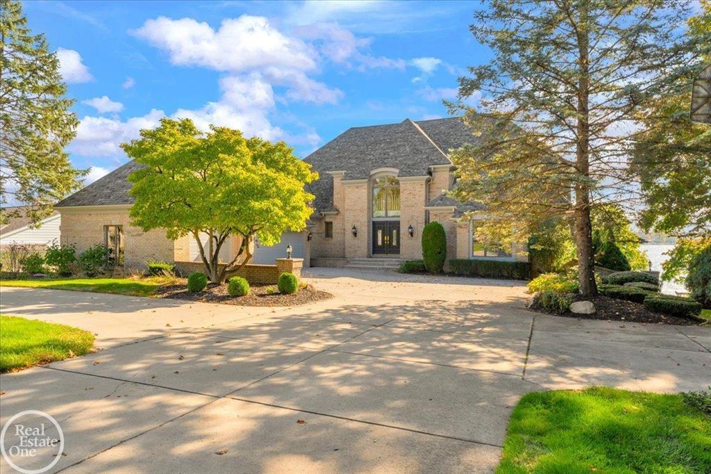 Exquisite custom St. Clair Riverfront home located on one of the best stretches of the river & just minutes from downtown St. Clair. This stunning property features over 5,000 sq ft of living space, including two primary suites one on the main level & an additional suite upstairs-perfect for multi-generational living. The grand foyer with circular staircase leads to a formal dining room and a spacious great room with fireplace and floor-to-ceiling windows offering panoramic river views. Chef's gourmet kitchen with large island, ample cabinetry, & all appliances included. Three fireplaces-one on each level-create warm, inviting spaces throughout. Executive library/den, finished walk-out basement with full second kitchen, bathroom, sauna, and hot tub. Multiple large decks and patios overlook the beautifully landscaped rear yard, providing the perfect setting to relax and watch freighters pass by. Attached 3-car garage. This exceptional property offers luxury, space, & scenic beauty in an unbeatable location.