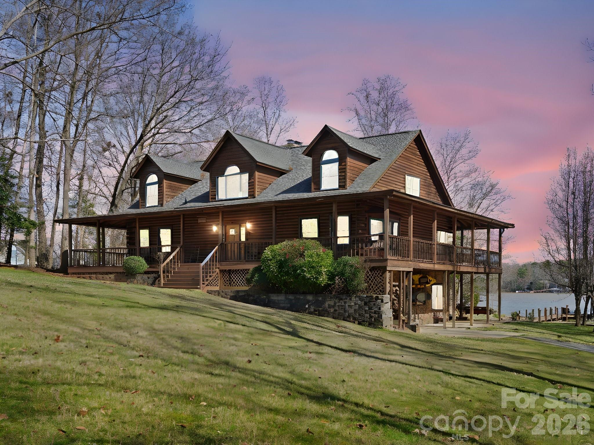 ALMOST 2 WATERFRONT ACRES COVERED DOCK BOAT LIFT 40X60 RV INSULATED GARAGE 4 CAR DETACHED GARAGE MASSIVE STONE FIREPLACE COVE WITH MAIN CHANNEL VIEWS RED CEDAR LOGS. Stunning 4,400 Sf Log Cabin on Lake Wylie Experience rustic log cabin living in this waterfront retreat on 1.95 acres with breathtaking three-sided main channel views. Constructed with high-quality Canadian Western Red Cedar logs, this home features vaulted ceilings, exposed beams, and an open-concept layout Home Features: 4 bedrooms, 4 full bathrooms across three levels Massive stone fireplace - living room and master Premium post and beam construction: 2x6 tongue-and-groove flooring Two driveway entrances Four-car detached garage (2,400 sq. ft.) 40x60 fully insulated metal building with 3 roll up doors covered dock with 7000 lb boat lift plus two jet ski docks Inground sprinkler Perfect for car enthusiast or anyone seeking a waterfront retreat.Award Winning Clover Schools