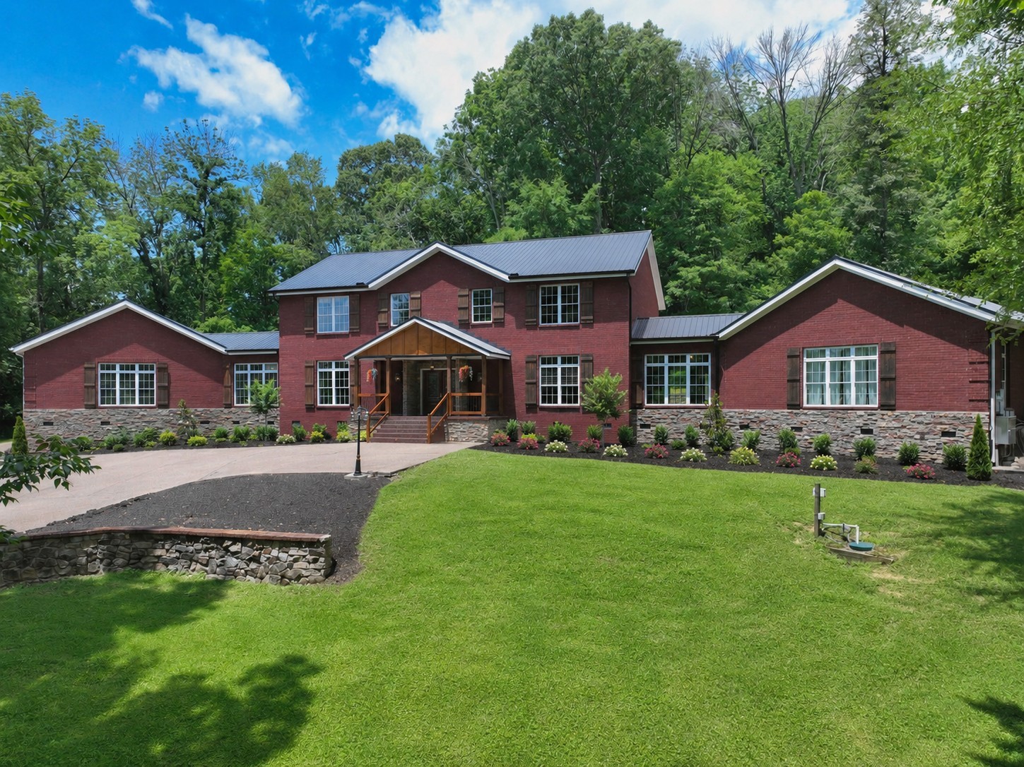 Exceptional 3-Acre Estate with Private Accessible In-Law Suite!  Rarely does a home offer this much space, character, privacy, and versatility.  Nestled on a beautiful 3-acre wooded lot in Goodlettsville, this impressive 7,000+ sq. ft. all-brick estate was built with exceptional craftsmanship, strength, and attention to detail.⭐ HIGHLIGHT: Fully Independent Handicap-Accessible In-Law Suite! Featuring its own living area, kitchen, bedroom, and full bath, this private wing is ideal for multigenerational living, extended family, guests, or anyone needing single-level accessibility.  Inside, you'll find gleaming hardwood floors, soaring ceilings, decorative tile, stained-glass pocket doors, and incredible architectural details throughout. The grand great room showcases a beautiful antique fireplace, while the chef's kitchen features solid oak cabinetry, marble and concrete countertops, stainless appliances, and an oversized walk-in pantry.  The luxurious primary suite offers his-and-her walk-in closets, a chandelier, and a spa-like bath with clawfoot soaking tub, fireplace, custom tile shower, and dual vanities.  Upstairs includes two spacious bedrooms, double closets, a full bath with oversized jetted tub, and abundant storage. A separate office/bedroom with half bath adds even more flexibility.  Outside, enjoy a circular driveway, two 2-car garages, RV shelter, and plenty of room for vehicles, hobbies, and outdoor enjoyment.  Built for lasting quality, this remarkable home was once described as one of the most insulated homes in Tennessee and was engineered to withstand an F3 tornado.  A truly unique estate offering luxury, space, accessibility, privacy, and exceptional construction—all in one unforgettable property. Come see it before it's gone!