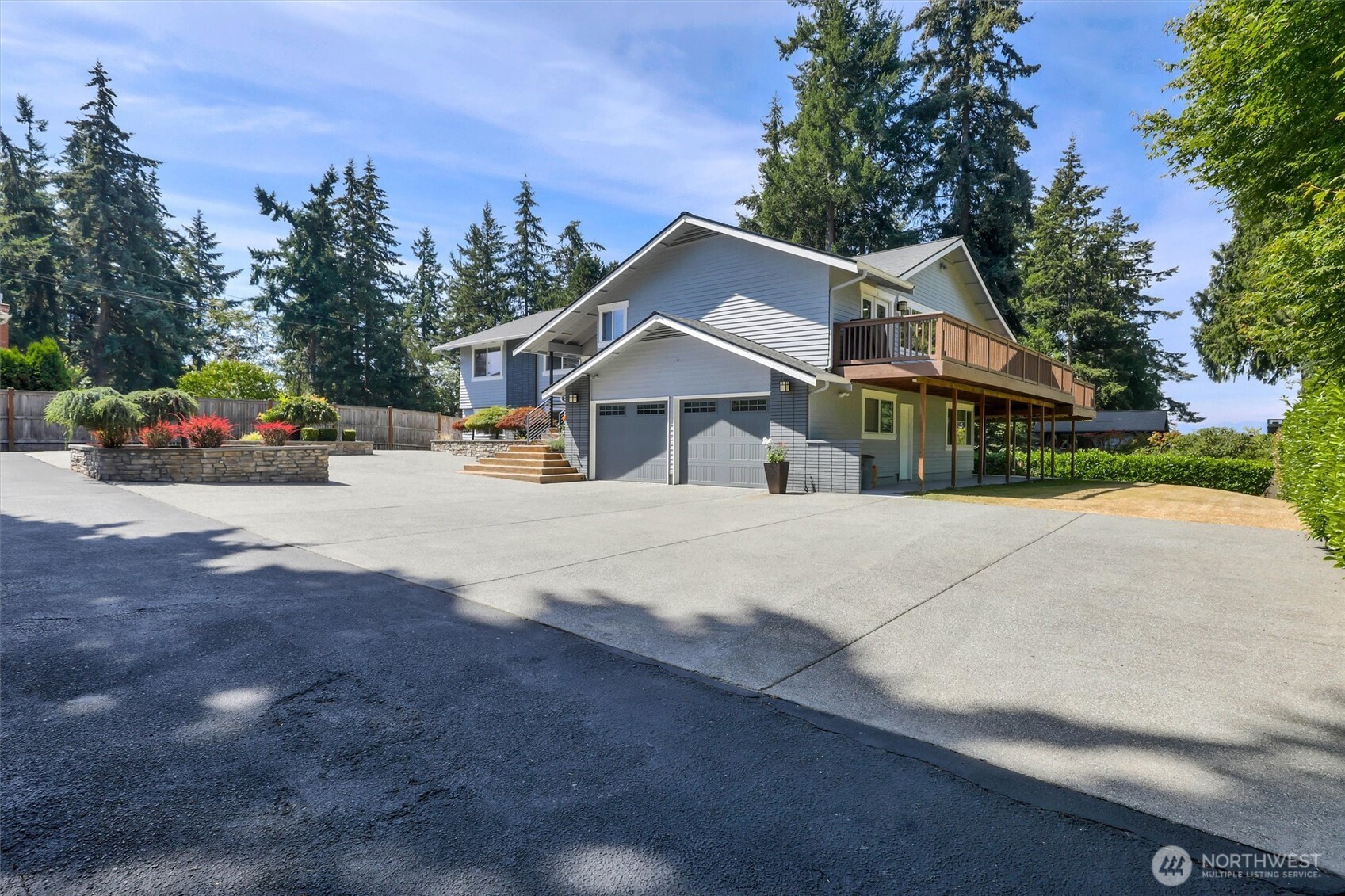 Tucked away on a private drive, this serene sanctuary pairs breathtaking Puget Sound views with incredible versatility and new pricing with extra income producing possibilities.  Step inside to a light-filled, open-concept main level featuring rich hardwood floors throughout and seamless indoor-outdoor flow. The chef’s kitchen is a true centerpiece, boasting classic white cabinetry, quartz countertops, an expansive center island, a gas stove, and stainless-steel appliances. French doors open from the main living area onto a wrap-around view deck—perfect for entertaining against a backdrop of lush greenary and water vistas.The main level hosts three bedrooms, including a restful primary suite complete with a beautifully updated bathroom and a walk-in closet and 2 more bedrooms plus a full bath. Downstairs, the versatile lower level offers two additional bedrooms, a spacious rec room, a dedicated office, and a functional laundry room.Bonus Living & Income Potential: A separate detached Detached ADU studio apartment—complete with its own updated kitchen and bathroom—sits above a generous 3-car garage. With ample vehicle parking, pristine privacy, and quick access to local parks and Meadowdale Beach, this compound offers a rare blend of retreat-style living and everyday convenience.