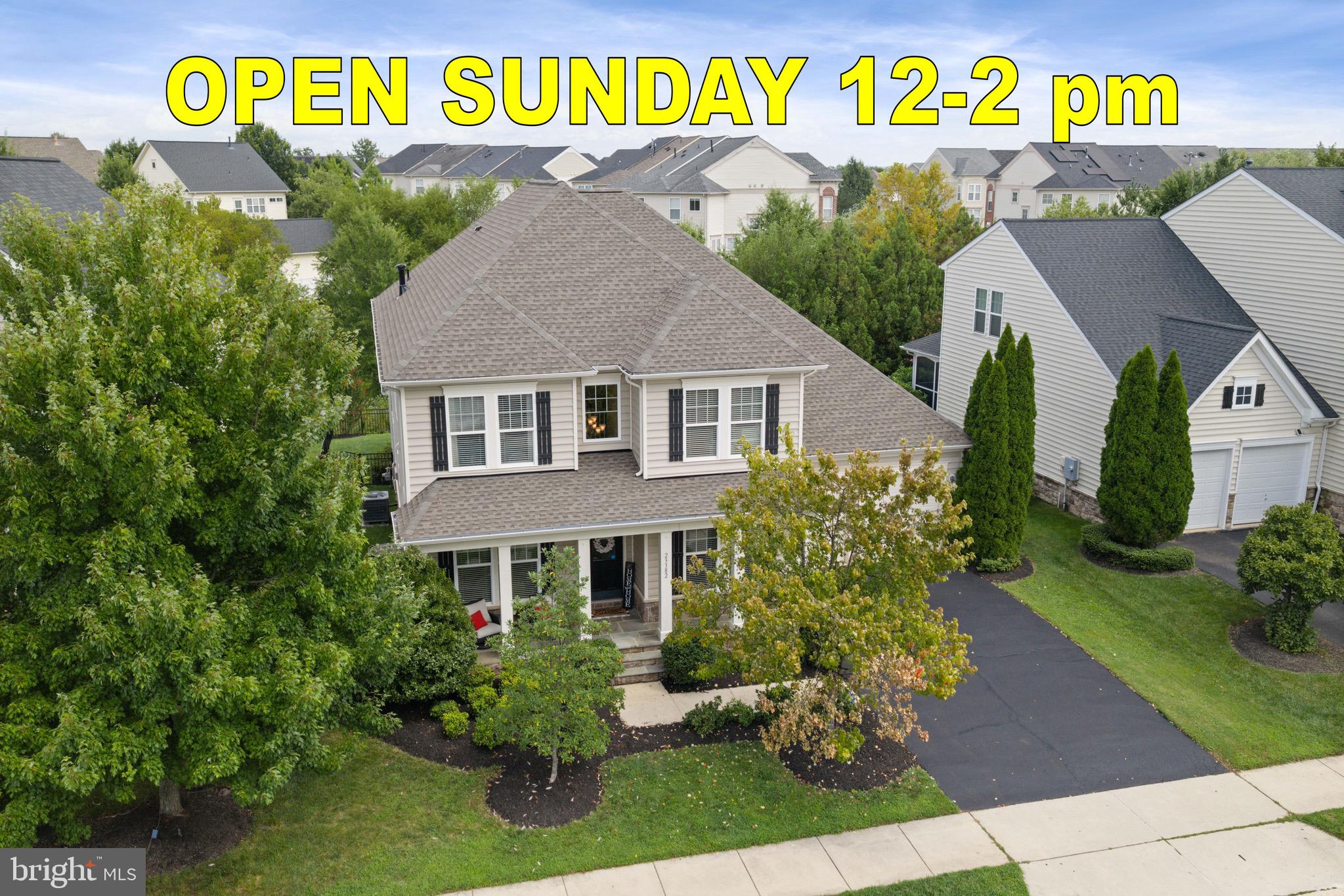 Set in sought-after Brambleton and backing to a peaceful backdrop of trees and common area, this exceptional five-bedroom, 3.5-bath Colonial offers more than 4,200 square feet of beautifully finished living space across three levels. From the inviting covered front porch to the extensive custom trimwork, refined finishes, and thoughtfully designed outdoor living spaces, this is a home where luxury and livability come together effortlessly.Inside, the open floor plan is enhanced by detailed moldings and beautifully refinished hardwood floors throughout the main and upper levels. A private home office is tucked behind elegant glass French doors, while the formal dining room provides a sophisticated setting for entertaining. The spacious family room centers around a striking stone gas fireplace and flows seamlessly into the breakfast room and beautifully updated kitchen.Designed to impress, the kitchen features crisp white cabinetry, a tile backsplash, custom quartz countertops, upgraded stainless steel appliances, a separate wine refrigerator, and an expansive center island with plenty of room for gathering. The adjoining breakfast area is exceptionally generous, easily accommodating a large table for casual meals and conversation.Upstairs, the oversized primary suite feels like a true retreat with a tray ceiling, two walk-in closets, a separate reading or sitting area, and a beautifully renovated luxury bath with a freestanding soaking tub, oversized frameless glass shower, updated tile, and elegant finishes. Three additional spacious bedrooms offer ample closet space and plush carpeting. An open hall area features a built-in workstation with room for multiple seats, creating the perfect homework, art, or study station. The laundry room is conveniently located on the bedroom level.The finished lower level adds tremendous versatility with a large recreation room, fifth bedroom with window, and third full bathroom, creating an ideal arrangement for guests or extended family. A projection TV, oversized wall screen, and built-in surround sound create an impressive home theater experience. A whole-house sound system extends throughout all three levels with separate controls on each floor.Outdoor living is equally impressive. The maintenance-free rear deck has been transformed into a true outdoor room with a covered roof, recessed lighting, ceiling fan, television, sound system, and privacy sunshades. Just beyond, a separate slate patio offers another inviting space for entertaining or relaxing. The fenced backyard backs to trees and common area for a wonderfully private setting. A brand-new roof was installed in August 2026.All of this is located in amenity-rich Brambleton, where everyday conveniences and recreation are close at hand. Enjoy community pools, tennis, pickleball, volleyball, clubhouses, miles of walking and biking trails, scenic lake views, and easy access to schools. Brambleton Town Center offers dining, shopping, movies, entertainment, and everyday essentials nearby, while major commuter routes and Dulles International Airport are within easy reach.Beautifully upgraded, generously sized, and designed for entertaining indoors and out, this remarkable Brambleton home offers an exceptional combination of luxury, comfort, and location.