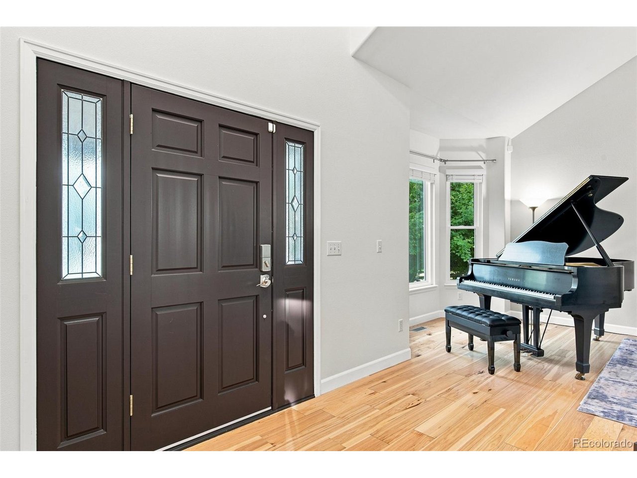 Welcome to this well-appointed Chardonnay Model, ideally situated on a quiet cul-de-sac backing to SES in the heart of Rock Creek. The handsome red-brick exterior opens to an inviting entry with a curved staircase and stunning hardwood floors. Formal living and dining rooms offer flexible entertaining space. The updated kitchen features newer appliances, granite countertops, contemporary tile backsplash, generous island, breakfast bar and nook, plus two pantries for excellent storage. The open-concept family room is filled with natural light from vaulted ceilings and nine windows, anchored by a gas fireplace. An executive office with built-in shelving accommodates multiple workstations. The main level also includes a tucked-away laundry, custom mudroom, and convenient 1/2 bath. Upstairs, four bedrooms and three baths include a serene primary suite overlooking the backyard, complete with a luxurious 5-piece bath, dual sinks, soaking tub, and two walk-in closets. Three additional bedrooms include one with a private en-suite bath. The basement offers a theatre room with stadium seating, workout room, 5th bedroom with 3/4 bath, recreation area, and partially finished crawlspace-ideal for storage or a playful hideaway. New paint, furnace, and A/C unit. Outside, the low-maintenance, drought-tolerant lawn minimizes yard upkeep. Conveniently located near shopping, dining, groceries, FlatIron Crossing, US-36, Denver, and Boulder.