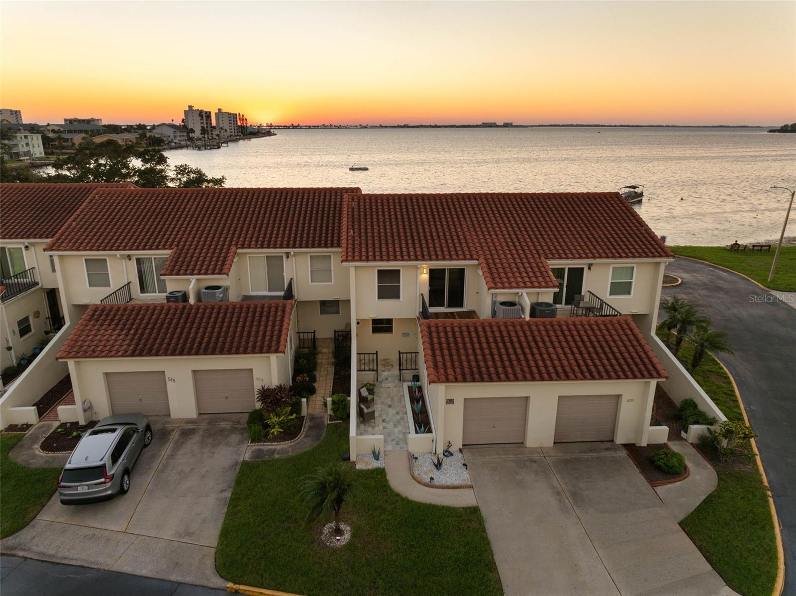 UNOBSTRUCTED GULF & INTRACOASTAL WATER VIEWS | DUNEDIN WATERFRONT TOWNHOME. Experience the best of Florida’s coastal lifestyle in this beautifully updated waterfront townhome in a sought-after Dunedin community, showcasing breathtaking, unobstructed views of the Gulf and Intracoastal Waterway. Step outside to a private patio with travertine pavers, offering a front-row seat to spectacular, colorful sunsets, dolphin sightings, and effortless waterfront entertaining. Inside, the updated kitchen impresses with elegant quartz countertops, abundant cabinetry, generous prep space, a built-in wine refrigerator, and a breakfast bar ideal for casual dining and entertaining. Stylish luxury vinyl plank flooring, updated fixtures, and contemporary hardware enhance the home’s refined coastal appeal. Upstairs, the private primary suite features an ensuite bath and spacious walk-in closet, along with a second full bathroom. A convenient half bath is located on the main level. Hurricane windows, a new HVAC system in 2026, and a new electrical panel in 2026 add valuable peace of mind. Enjoy an exceptional array of community amenities, including a private beach and park, kayak storage, heated swimming pool, pickleball and tennis courts, and two clubhouses featuring a fitness center, library, kitchen, and organized social activities. Ideally located minutes from Honeymoon Island State Park and approximately 10 minutes from downtown Dunedin, you’ll enjoy easy access to boutique shopping, the popular farmers market, waterfront dining, local breweries, nightlife, and year-round community events. Direct waterfront views, beautifully updated interiors, and resort-style amenities combine to create an extraordinary opportunity to be a part of Dunedin's coastal lifestyle. Schedule your private showing today!