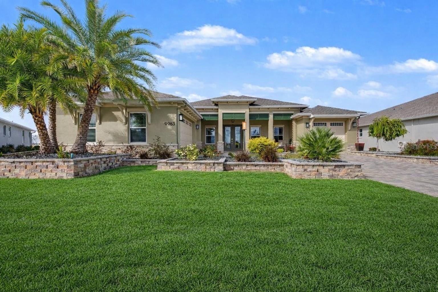 Located in the desirable Ashford neighborhood of Ocala’s renowned On Top of the World 55+ community, this stunning 2023-built home blends modern luxury with resort-style living. Featuring 3 bedrooms, 3 bathrooms, a desirable split-bedroom layout, and both a 2-car plus separate 1-car garage, this residence is loaded with premium upgrades throughout. The heart of the home showcases new Bosch appliances in a true chefs kitchen, Luxury Italian tile flooring throughout, custom lighting, Minka Aire ceiling fans, and beautifully upgraded showers in both primary suites with rain heads. Stone accents enhance both the interior and exterior, while custom closet shelving adds everyday convenience.Step outside to your private oasis—an enclosed heated saltwater pool and spa, finished with pavers, natural gas heat, safety barrier, and pre-plumbing for a future summer kitchen. The covered patio includes ceiling fans and natural gas for grilling, perfect for year-round enjoyment. Professionally designed landscaping features block walls, new plants and trees, rock beds, and app-controlled architectural and landscape lighting with endless color options.The garage space is equally impressive with full insulation, insulated doors, polyaspartic floors, custom shelving, and mini-split climate control. Residents enjoy access to unmatched community amenities with multiple golf courses, fitness centers, and even more to come—including a high-end fitness center and 9-hole golf course just a couple turns away. This home offers the perfect balance of luxury, comfort, and an active lifestyle—schedule your private showing today.