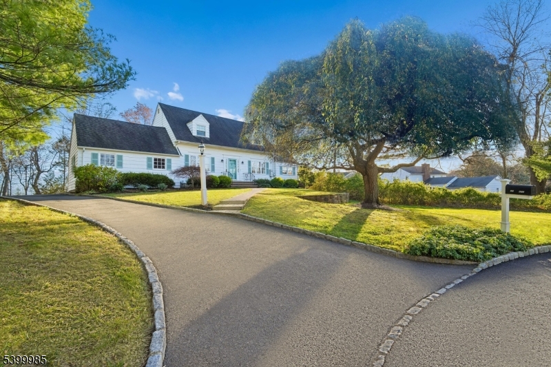 PERFECTLY NESTLED ON A HIGHLY SOUGHT-AFTER CUL-DE-SAC WITH PICTURESQUE NYC SKYLINE VIEWS on almost half an acre of FLAT land, this lovingly maintained 3-bedroom, 2.5 bath Colonial is a place you'll be proud to call home! Quality upgrades include: a fully renovated kitchen featuring stainless steel appliances, quartz countertops, custom cabinetry, and white oak hardwood floors. All bathrooms have been tastefully renovated with modern fixtures. Original built-ins and crown molding in the living and dining rooms add timeless character, complemented by white oak hardwood floors throughout the home. California Closet systems enhance the bedrooms and bathroom, providing exceptional organization. A spacious backyard deck and flagstone patio overlook the flat, park-like yard, ideal for entertaining on warm summer nights, and provide a winter view of sparkling city lights that create a breathtaking backdrop year-round. Additional highlights include a Generac standby generator, ADT security system with Nest doorbell, full HVAC replacement (2020), newer garage door, and a lawn irrigation system. The property features well-manicured landscaping with clematis, peonies, and dogwood trees. Perfectly located, this home is within walking distance to the Watchung Reservation and Trailside Museum and minutes from Watchung Stables and Echo Lake Park. Excellent commuter access just 8 min to NJ Transit bus service and 15 min to Westfield/Summit train service complete this exceptional offering.