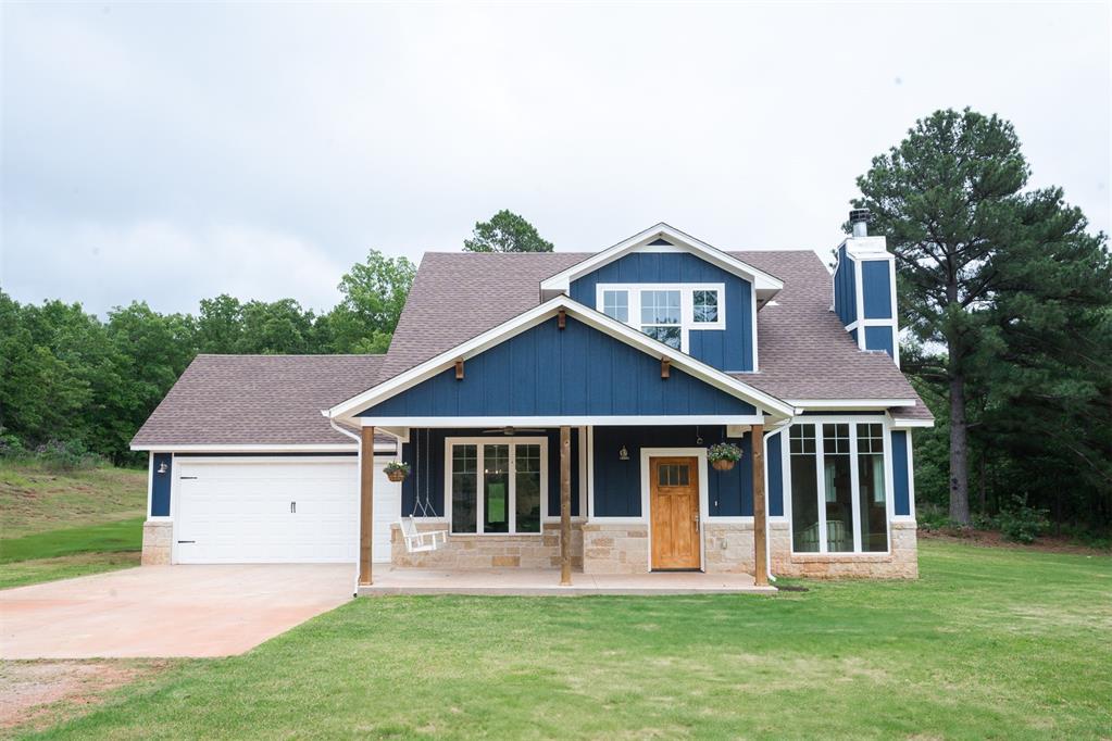 Discover this beautiful 3-bedroom, 2.5-bath home with a 2-car garage, perfectly positioned on a scenic pond in the peaceful community of Hidden Pines Estates. A true retreat, this home offers comfort, space, and plenty of natural light. Step inside to an inviting living room with a fireplace and walls of windows that bring the outdoors inside. The open-concept design connects the formal dining area to a well-equipped kitchen featuring a large island, breakfast bar, walk-in pantry, and abundant storage—ideal for hosting and everyday life. You’ll find two large bedrooms with walk-in closets—one currently serving as a home office. The spacious primary suite includes dual sinks, walk-in shower, and an oversized closet that connects to the laundry. This energy-efficient home uses propane for the kitchen stove and fireplace. The backyard offers room to grow with a storm shelter already in place and plenty of space for outdoor fun. The stocked pond is perfect for fishing, relaxing, or entertaining guests. Whether you're looking for peaceful lake views, room to roam, or a place to gather with loved ones—this home has it all.