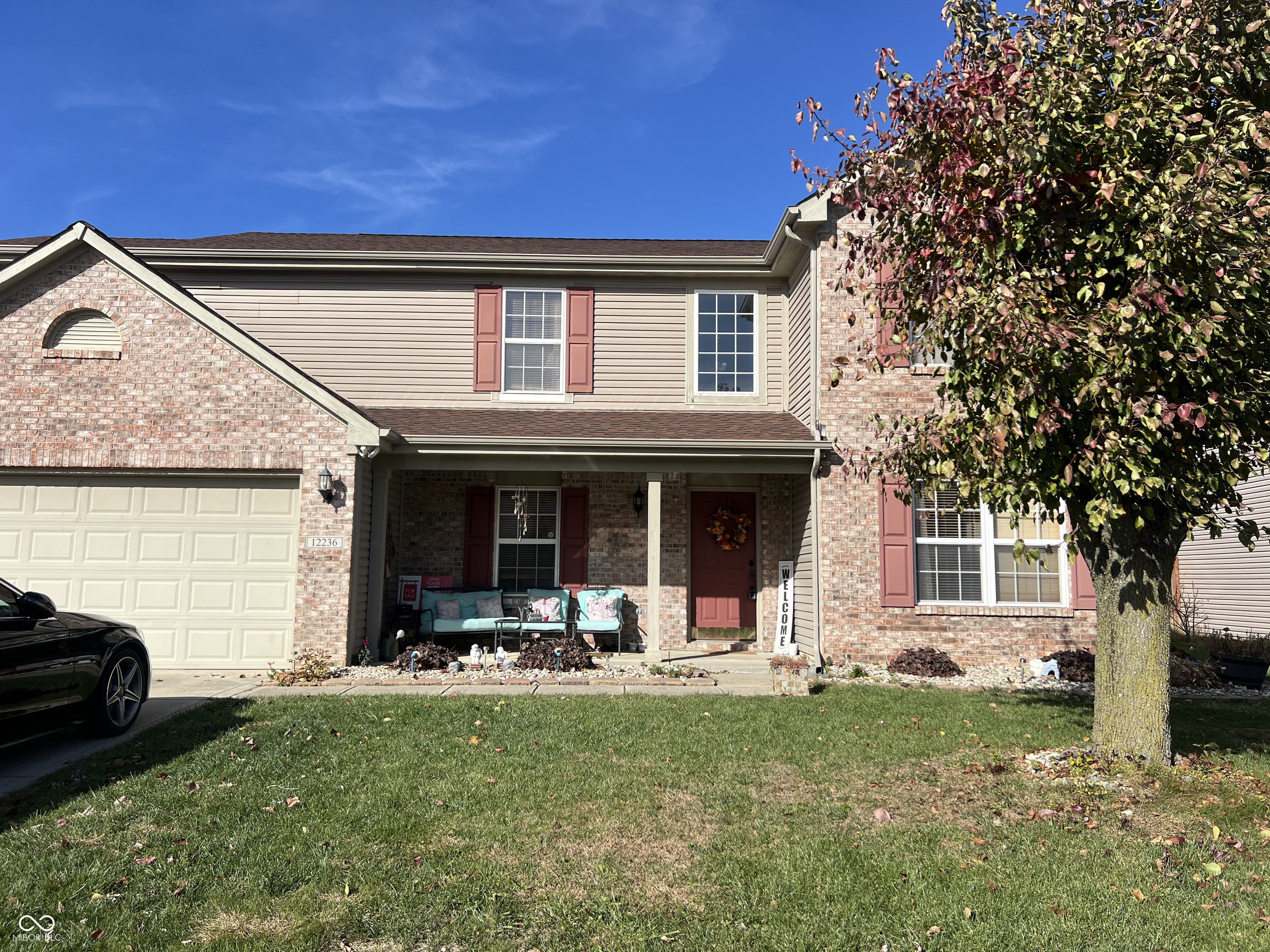 Oh, hello there, future homeowner! Isn't it time you treated yourself to a slice of the good life? Nestled at 12236 Quarterback LN, FISHERS, IN, this single-family residence in Hamilton County is waiting to become your personal paradise, and it's in great condition, too!  Picture this: you, lounging in your living room, the fire crackling merrily in the fireplace while the vaulted ceiling soars above you, creating a sense of expansive calm. The possibilities are endless within this space, so bring your imagination.  The kitchen is calling your name, with its fabulous kitchen bar and large kitchen island just begging for you to gather around with friends and family. Shaker cabinets stand ready to house all your culinary gadgets and gizmos, making meal prep a breeze.  Imagine stepping into your bathroom, greeted by the elegance of a double vanity and the sleek design of a walk-in shower. It's like having a spa day, every day!  Outside, the fenced backyard is your blank canvas for outdoor fun. A fire pit promises cozy evenings under the stars, while the porch and patio provide perfect spots for sipping sweet tea and soaking up the sunshine.  With 2456 square feet of living area on a generous 8276 square foot lot, and featuring 3 bedrooms and 2 full and 1 half bathrooms across 2 stories, this 2006-built charmer is more than just a house; it's your opportunity to live the dream.