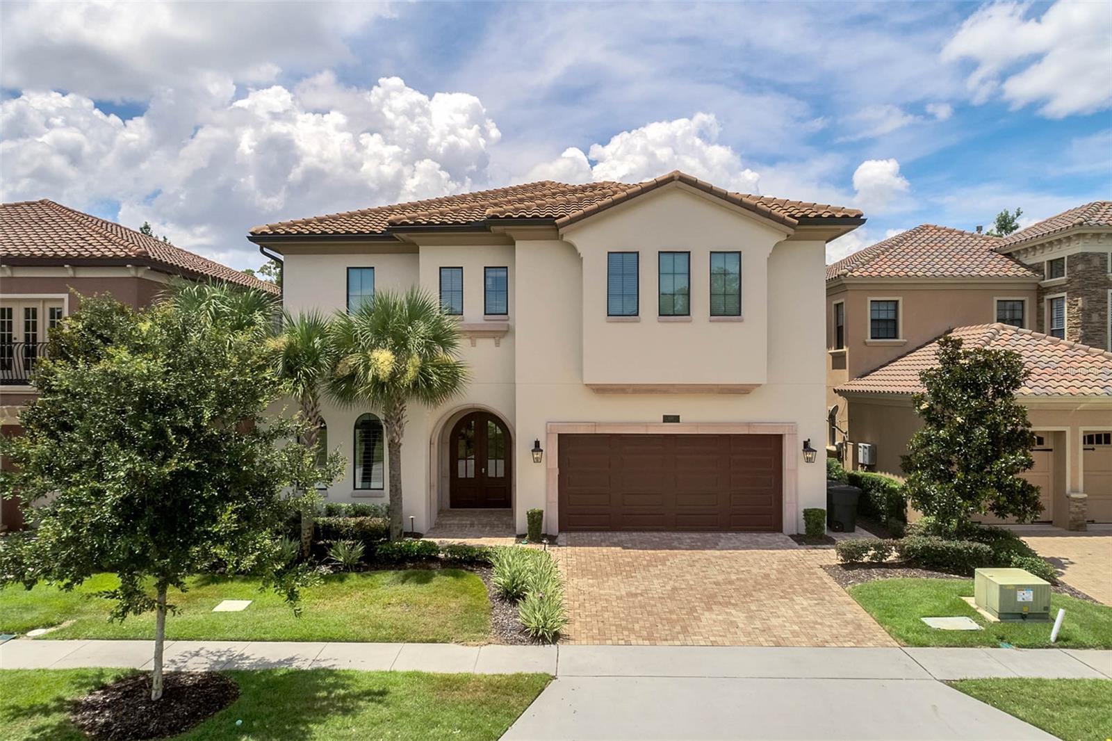 Completely refreshed contemporary style home with Spanish tile roof, curved archway double door with wrought iron design. This home was truly designed to impress with custom upgrades throughout that includes elongated tile floors, triple wide in-wall fireplace feature with beautiful wood beam ceilings. The 7 bedroom baths home boasts 6455 Sq Ft under air to provide you and your family a large open floorplan that can accommodate up to 26. Chef inspired kitchen with Electrolux double fridge, double oven and 5 burner gas stove with hammered copper hood. Enjoy the west facing swimming pool and spa that is a true oasis with a spectacular summer kitchen, projection TV, covered wet bar area with fountain water feature, plus an open patio with an abundance of seating sections overlooking private conservation views. There are 2 commercial quality arcade rooms that include basketball, Star Wars, air hockey, Daytona racing game and 3 gaming screens plus upstairs loft area with pool table, foosball and shuffle board games, 3 tier TV system located next to the 10 seat themed theater room with high end projection system. The adventure room has 6 bunk beds with a full tunnel system and quick escape slides. For the Princess Room, there are 4 sleeping chambers with icy themed slide. Downstairs master bath is a double walk in with dual shower heads and oversized soaking tub. Reunion includes 12 community pools, 3 Signature Golf Courses, water park, 7 restaurants, 2 golf shops, 6 Hydro-Grid Clay tennis courts, a full-service spa and much more!