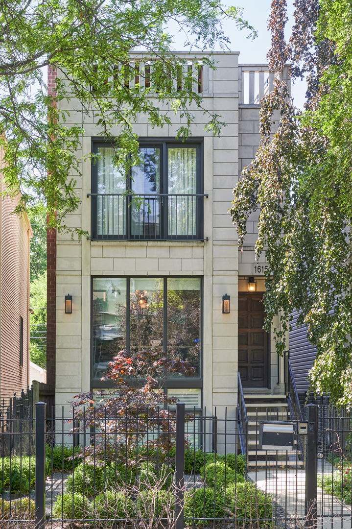Turnkey, design-forward property in one of Chicago's hottest neighborhoods-Ukrainian Village. This impeccable single-family home has 4,000 meticulously curated square feet with 4 bedrooms, 3.5 bathrooms and 4 outdoor spaces. Exceptional curb appeal with a striking limestone and brick facade, a fenced landscaped front yard, and mature trees. Inside, clean architectural lines meet custom finishes immediately in a large living/dining room with high ceilings and a fireplace. A floating staircase acts as a sculptural centerpiece, while designer light fixtures, hardwood floors, and bespoke millwork set an elevated tone. Built for both entertaining and comfortable daily living, the open-concept main level continues with a stunning chef's kitchen with custom cabinetry by New Style, professional-grade appliances including a Wolf range, double ovens, refrigeration drawers, quartzite counters and backsplash, and a built-in wet bar with wine fridge. Glass accordion doors connect the family room with natural wood built-ins to a 10' x 8' back deck. Above the garage, a larger 400 SF deck includes a built-in grill and stove, pergola with heat lamps, and a full A/V setup. Upstairs, the second level boasts a spacious primary suite with two custom walk-in closets, a 9' x 8' balcony, and a spa-quality ensuite bath featuring a dual vanity with tambour detailing and a large glass steam shower. Two additional bedrooms (one is currently a home office) and a full bath complete this floor. Better still, this spectacular home has a show-stopping 18' x 67' rooftop deck. It's an entertainer's dream with another folding window wall to reveal a full bar clad in soapstone, refrigeration drawers, a sink, a dishwasher, and floating barware shelves. Two large seating areas, one with fire table, are both framed by panoramic skyline views. The lower level offers exceptional flexibility with a sunlit recreation/media room, a full bath, a laundry room, a guest bedroom, and a 13' x 6' storage room. Additional design details include marble tile, luxe wallcoverings, statement lighting, and beautiful fixtures and hardware throughout. Near amazing restaurants, nightlife, and the Grand Avenue Design District, with easy access to I-94 and the Loop, 1615 W Huron is refined living on Chicago's near west side.